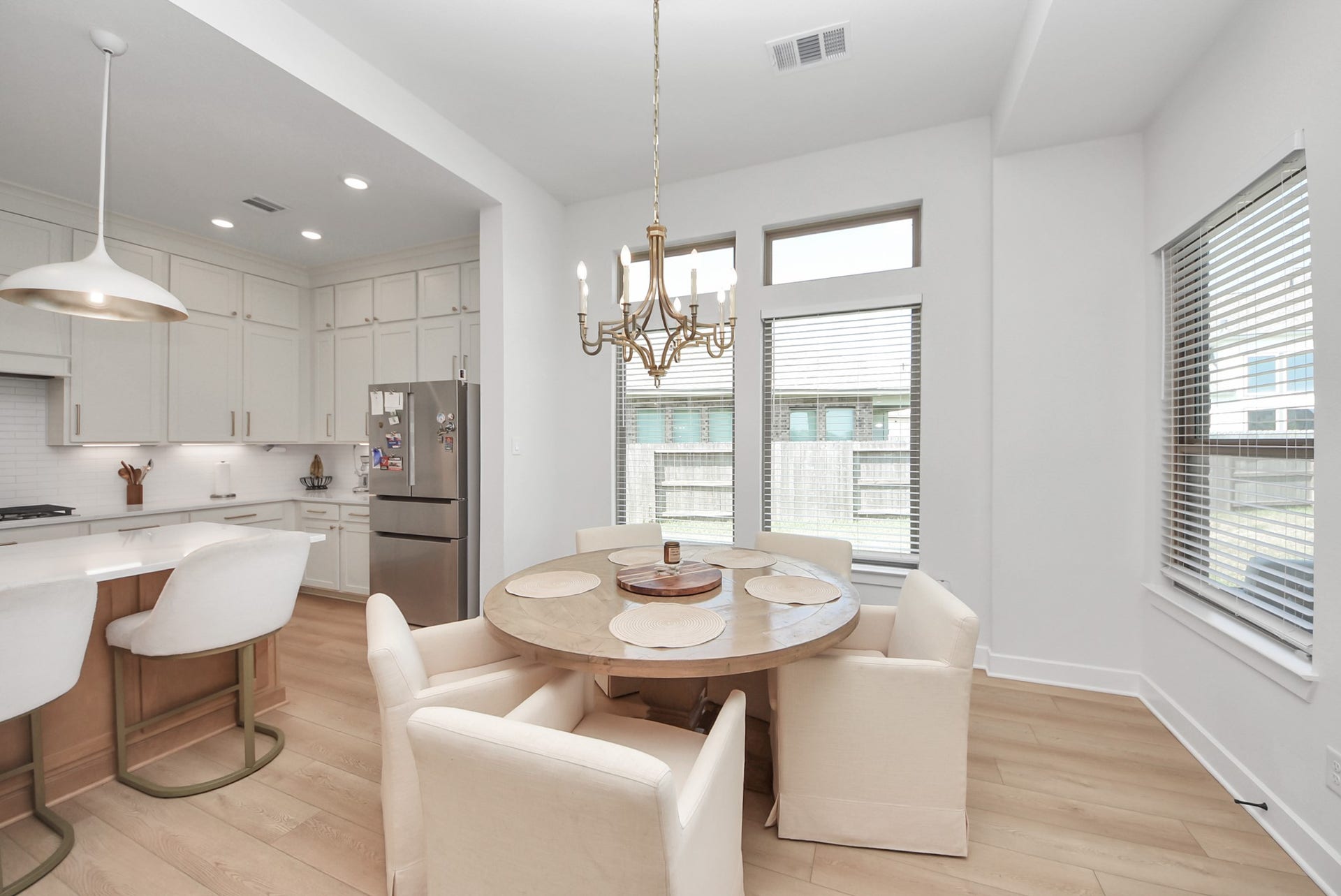 2995 Tantara Drive, Katy, TX 77493 Bright and inviting kitchen and dining area with modern lighting, sleek cabinetry, and a cozy breakfast nook perfect for gatherings.