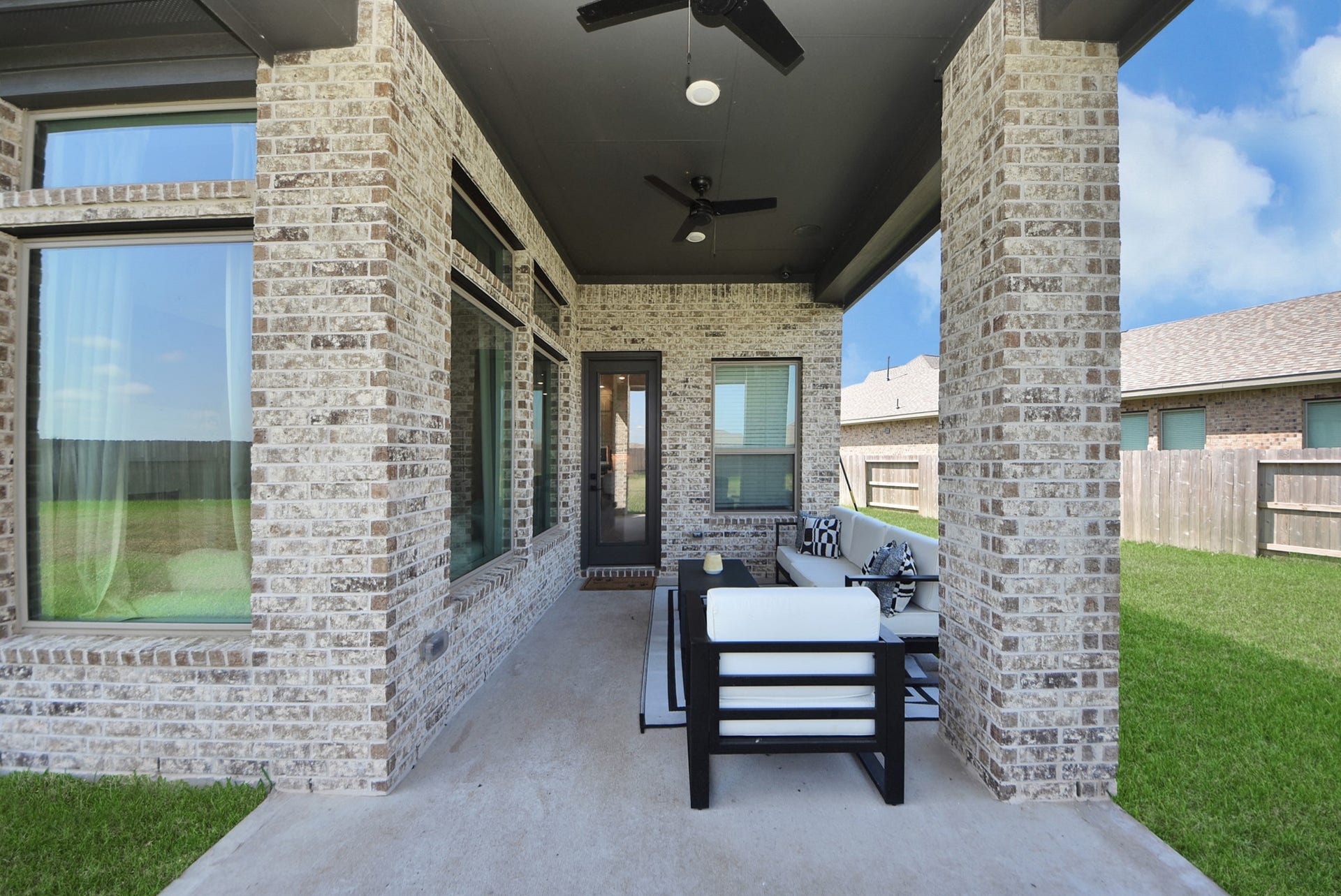 2995 Tantara Drive, Katy, TX 77493 Charming covered patio with elegant brick detailing, perfect for outdoor relaxation and entertaining.