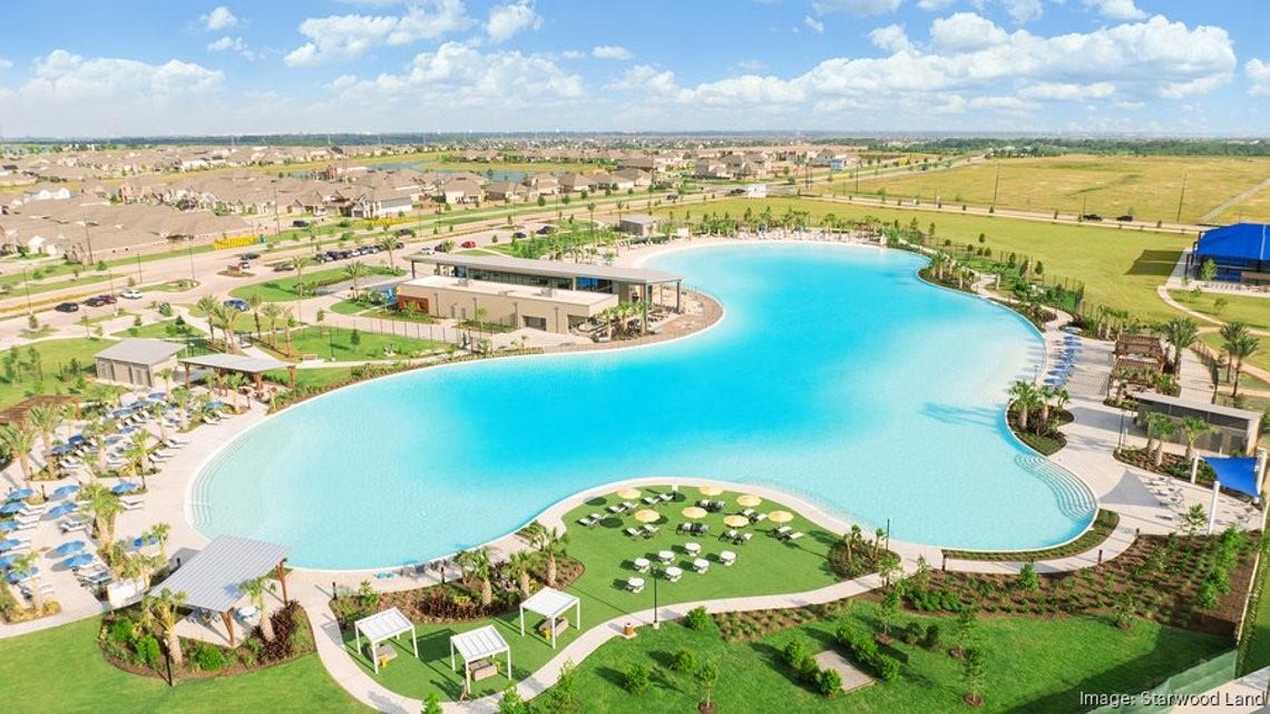 2995 Tantara Drive, Katy, TX 77493 Experience resort-style living with a stunning, expansive lagoon pool, surrounded by lush landscaping and modern amenities, perfect for relaxation and recreation.