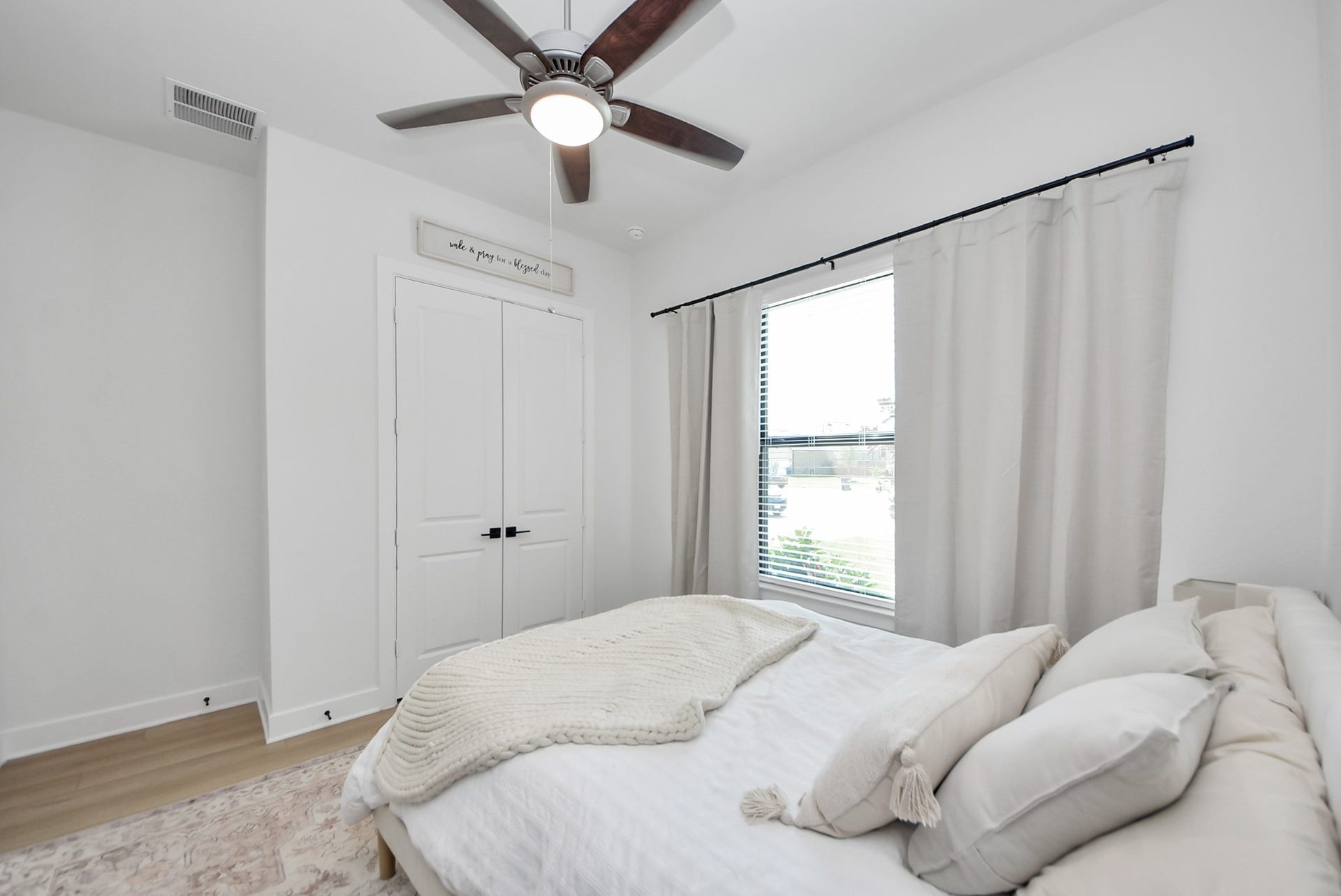 2995 Tantara Drive, Katy, TX 77493 Cozy bedroom with abundant natural light, featuring a ceiling fan, soft white walls, and a spacious closet with double doors.