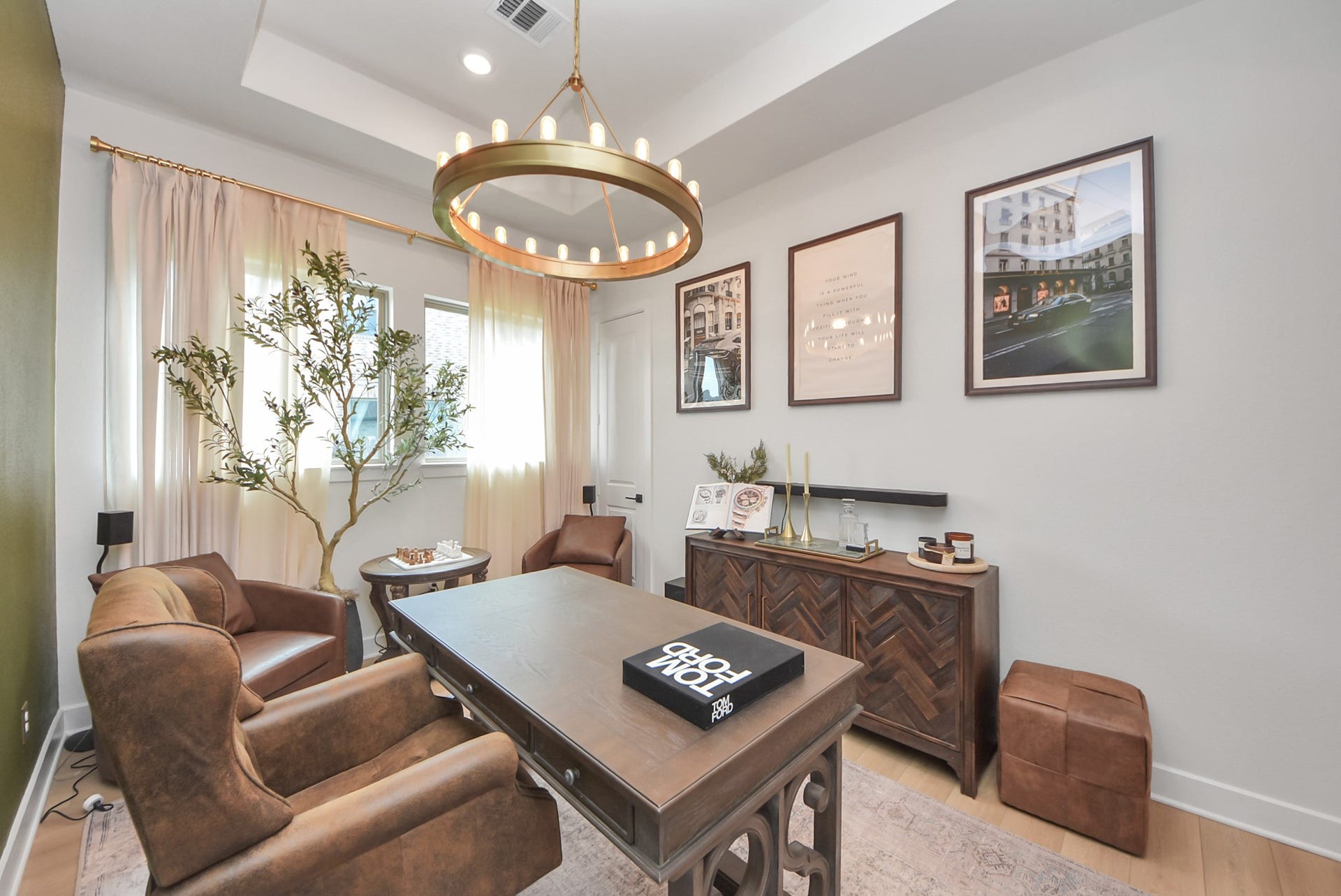 2995 Tantara Drive, Katy, TX 77493 Elegant home office with rich leather seating, a stylish wooden desk, and modern decor, enhanced by natural light and a chic chandelier.