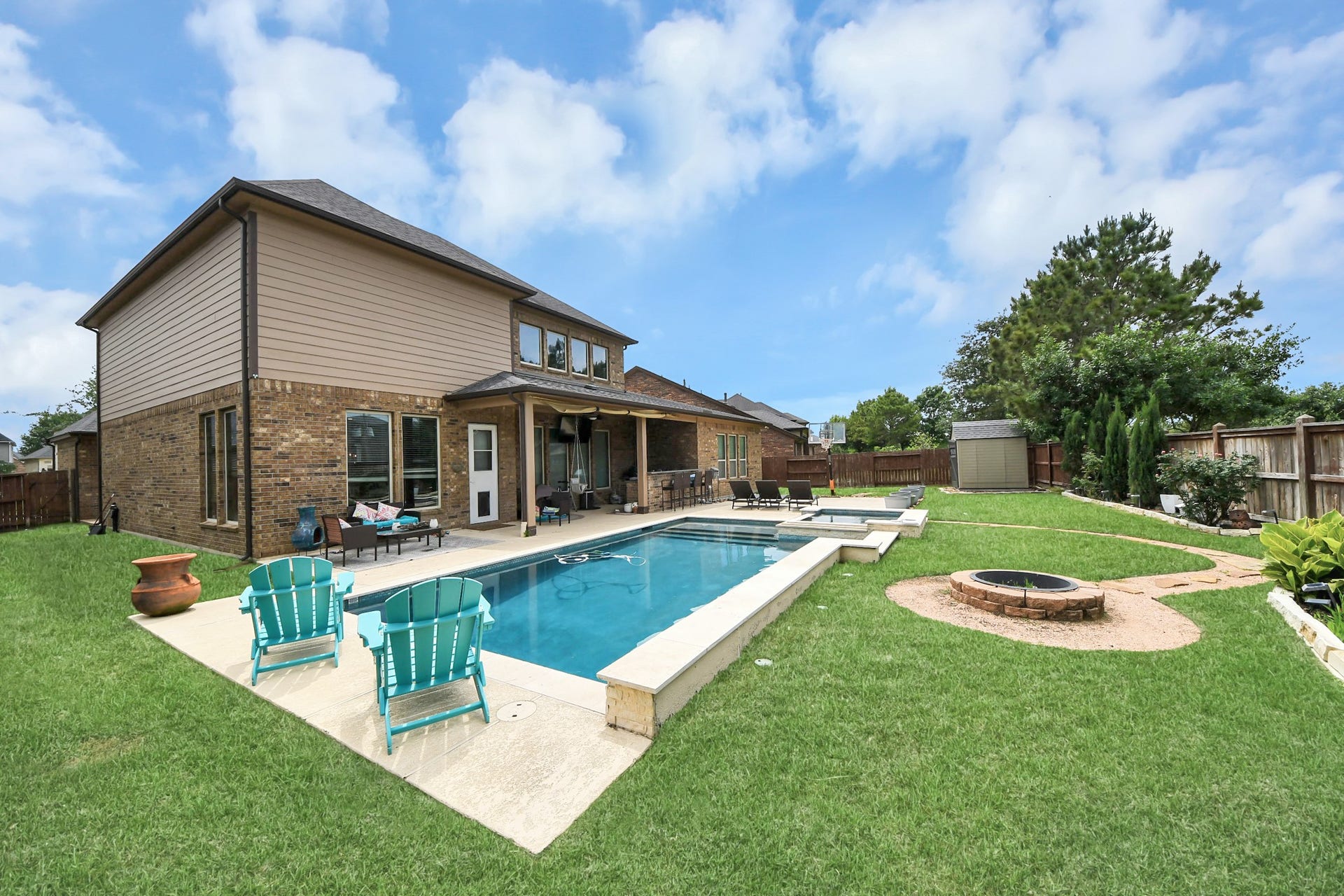 14926 Dogwood View Lane, Cypress, TX 77429 Relax in your private backyard oasis including a pool, spa, outdoor kitchen and plenty of seating to sunbathe of host your loved ones!