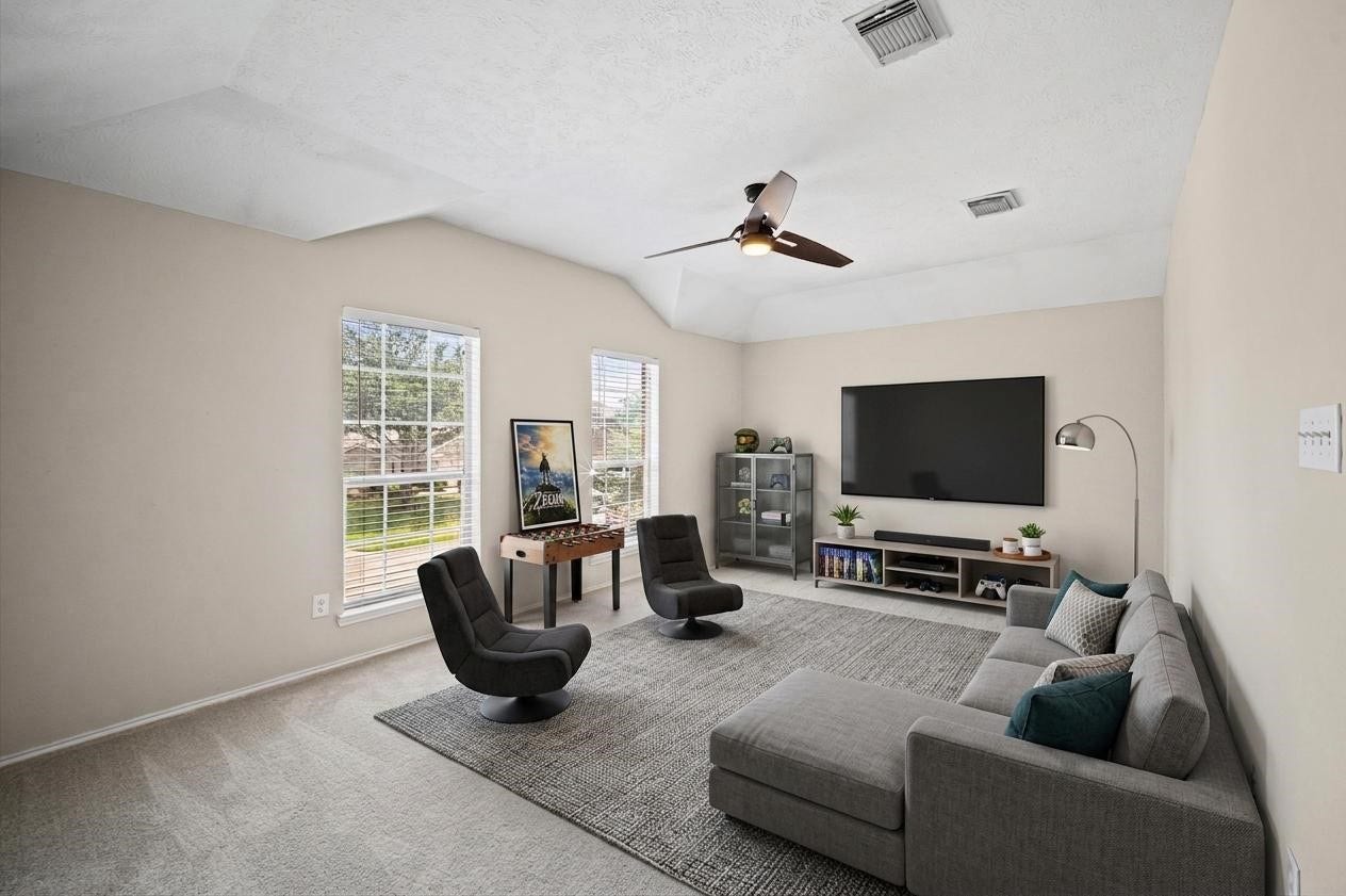 8711 Sandusky Court, Tomball, TX 77375 This spacious game room has a lot of natural light that pours in through two big windows, Ideal for relaxation or entertaining.