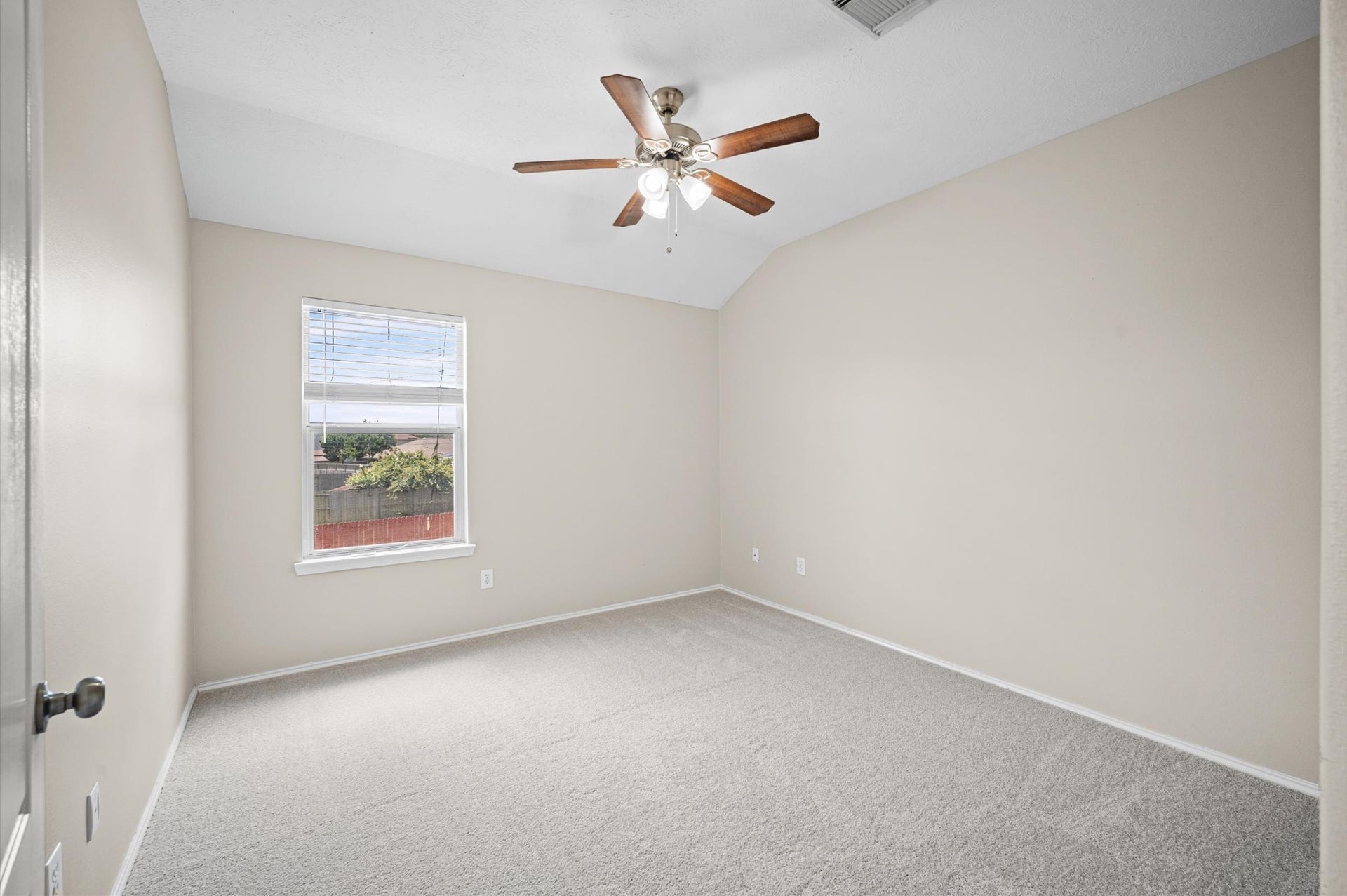 8711 Sandusky Court, Tomball, TX 77375 This room is bright and inviting, featuring neutral walls and new carpeting. It includes a window with natural light and a ceiling fan for comfort. Ideal for a bedroom or office space.