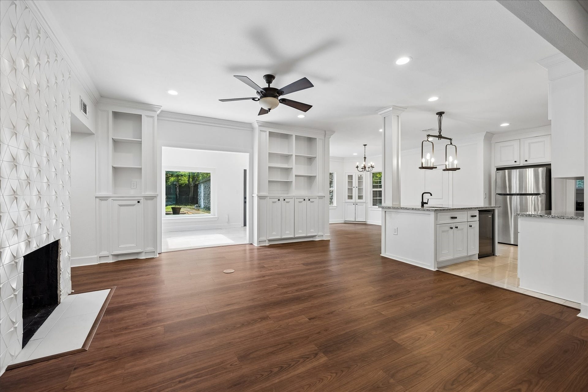 3071 Locke Lane, Houston, TX 77019 Light-filled formal living area with hardwood flooring and oversized windows.
