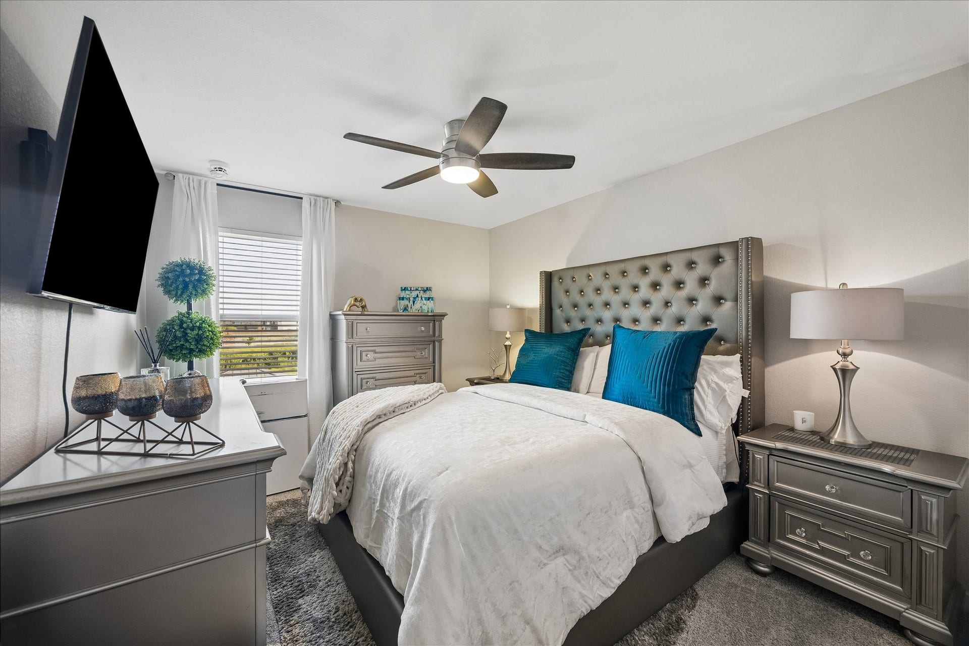 3034 Crown Gate Drive, Houston, TX 77047 Comfortable secondary bedroom with ceiling fan, natural light and space for a full bedroom setup.