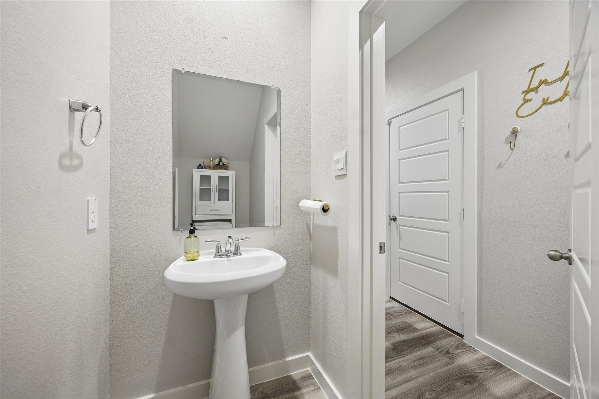 3034 Crown Gate Drive, Houston, TX 77047 Convenient downstairs half bath with pedestal sink, perfect for guests.