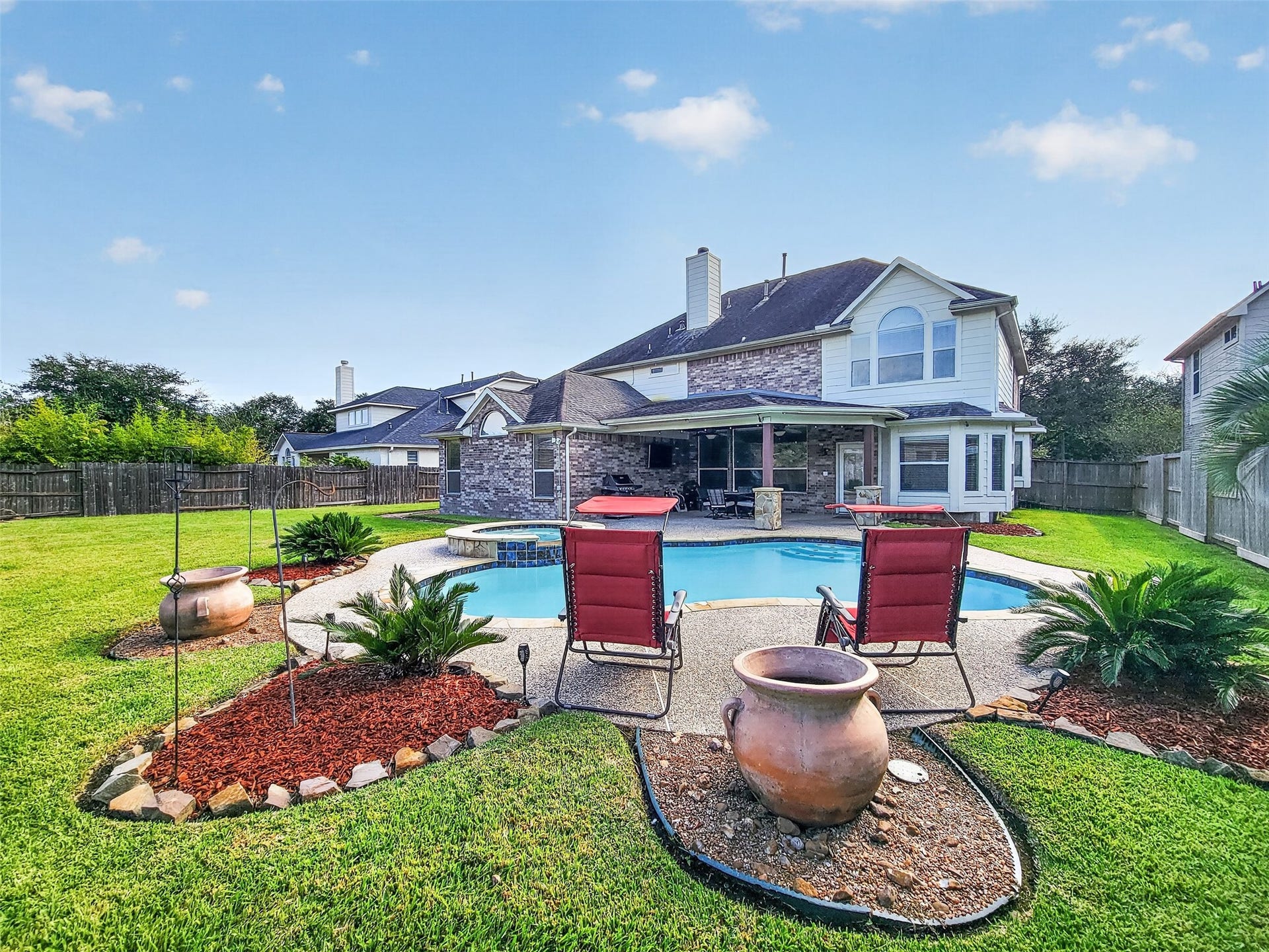 2006 Linden Cove Court, Katy, TX 77494 Enjoy outdoor living in this spacious backyard featuring a sparkling pool, lush landscaping, and a charming covered patio perfect for entertaining.