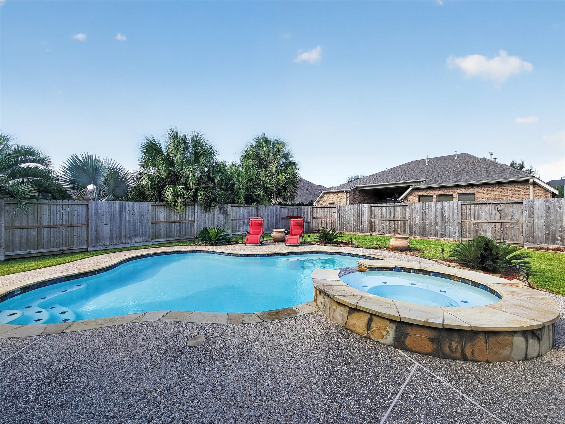 2006 Linden Cove Court, Katy, TX 77494 Enjoy a private oasis with a sparkling pool and spa, surrounded by lush greenery and a spacious patio, perfect for relaxation and entertaining.