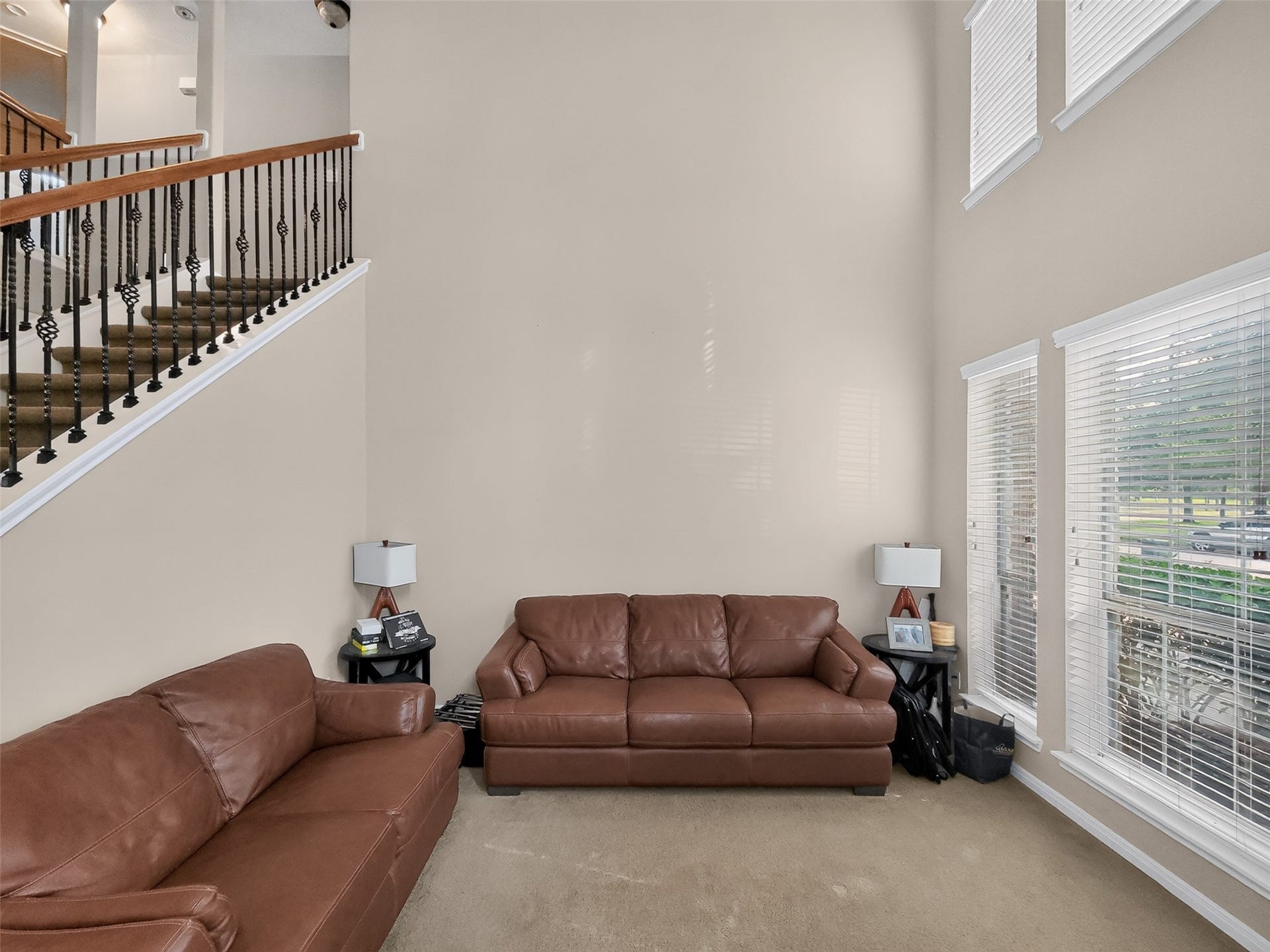 2006 Linden Cove Court, Katy, TX 77494 Spacious living area with high ceilings, natural light from large windows, and elegant staircase, creating a welcoming atmosphere.