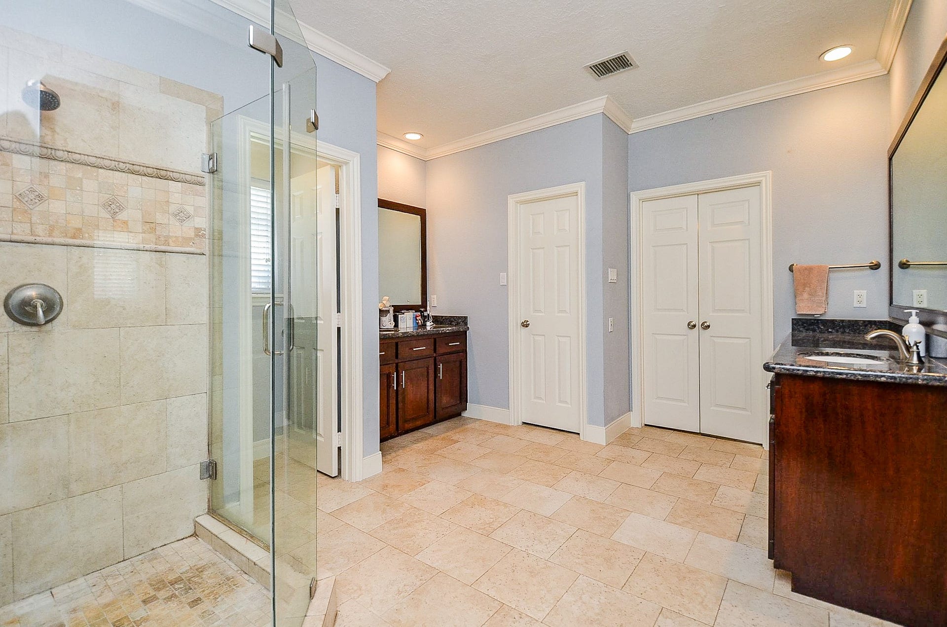 Luxurious walk-in tiled shower in primary suite