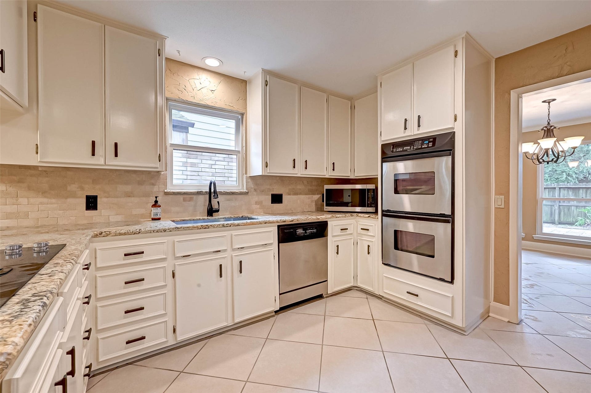 Kitchen has updated appliances and cabinets to the ceiling!