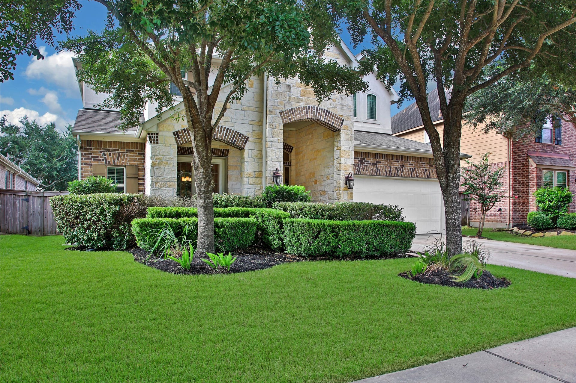 Nestled behind mature landscaping, this beautiful home offers exceptional curb appeal.