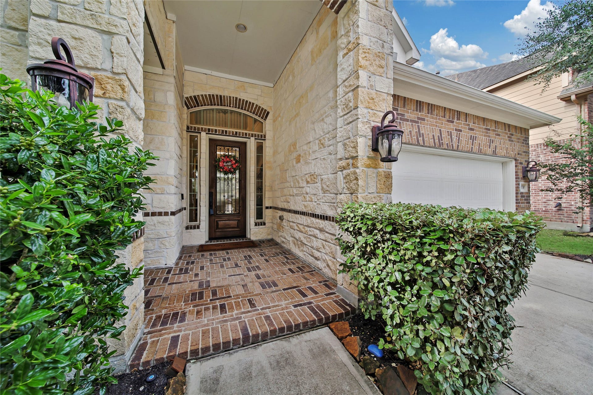 The deep covered entryway creates a grand first impression while providing a welcoming and sheltered space for guests.