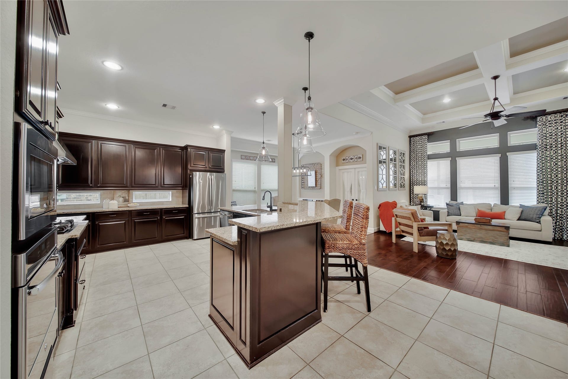 The kitchen opens seamlessly to the living room, creating a spacious and inviting gathering area.
