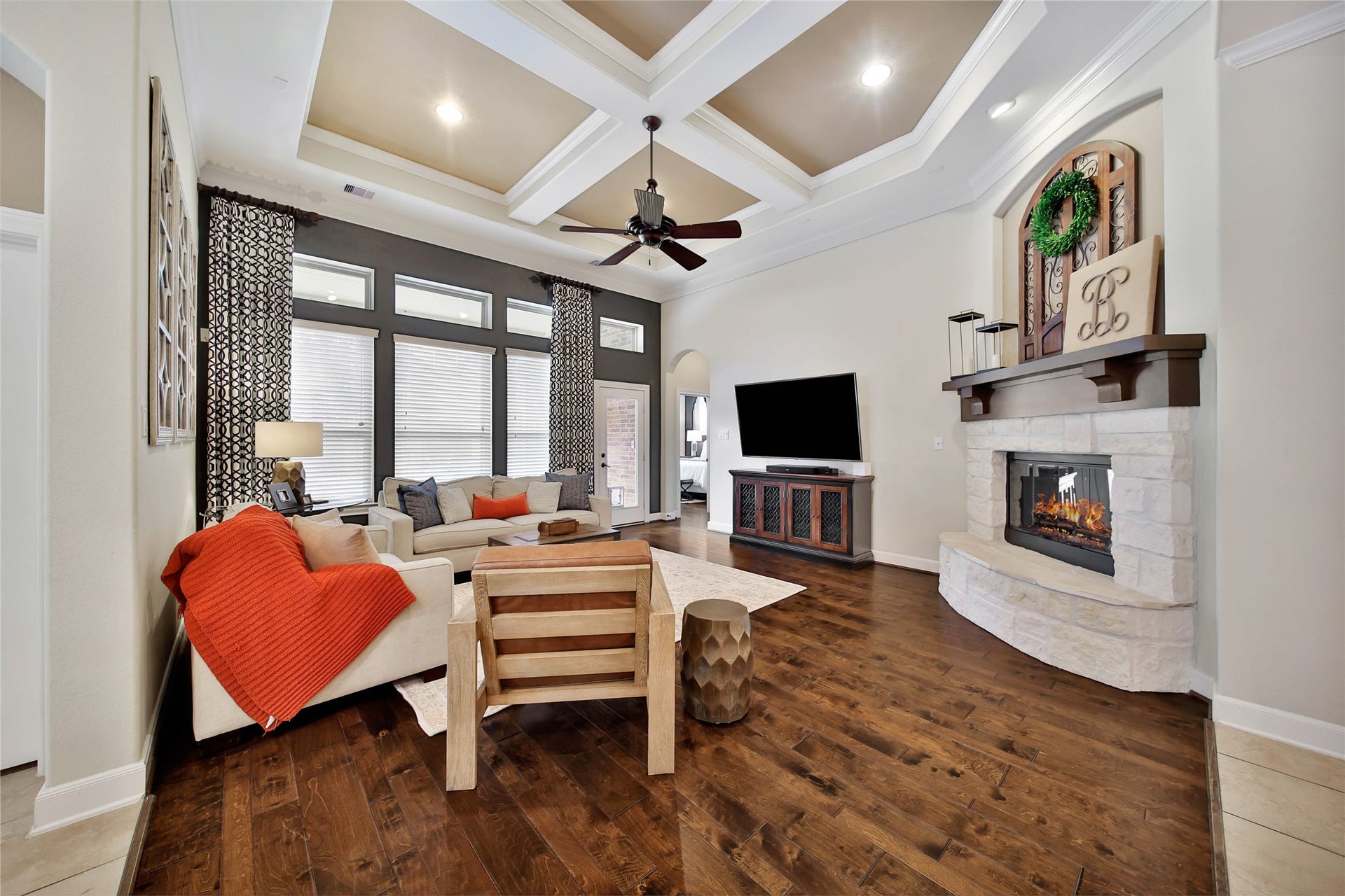 The stunning stone fireplace with a raised hearth and wood mantle creates a beautiful focal point, adding warmth and character to the living space.