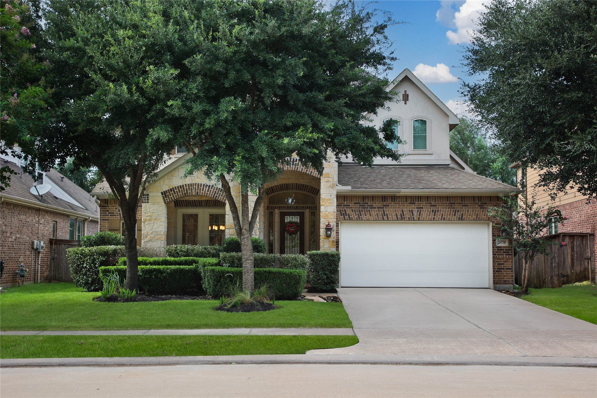 Brick and Stone combine to create a stunning 
exterior on this 4 BR/ 3.5 Bath Chesmar home.
Two car garage is complete with an EV charger!