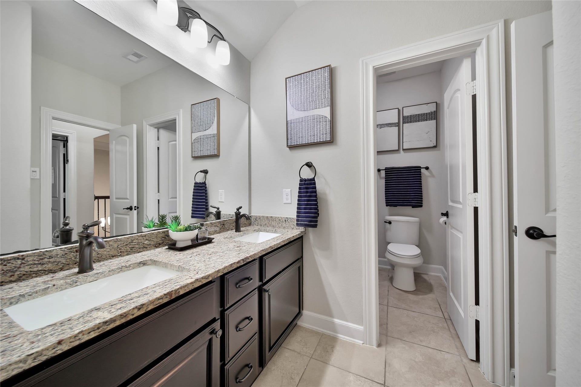 Full Bath with dual sinks and a tub/shower combo.