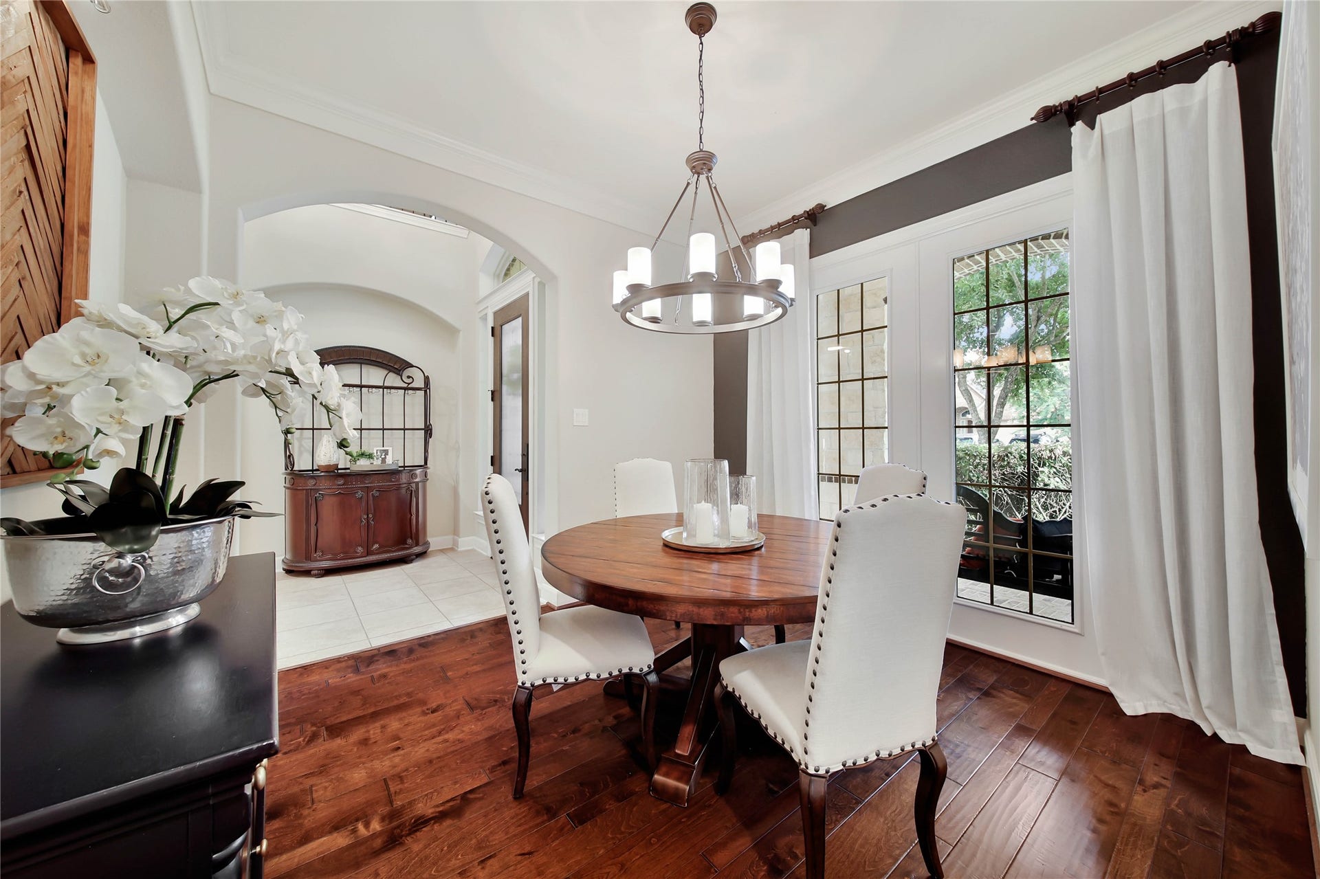 The elegant living room showcases rich wood floors, creating a warm and inviting atmosphere.