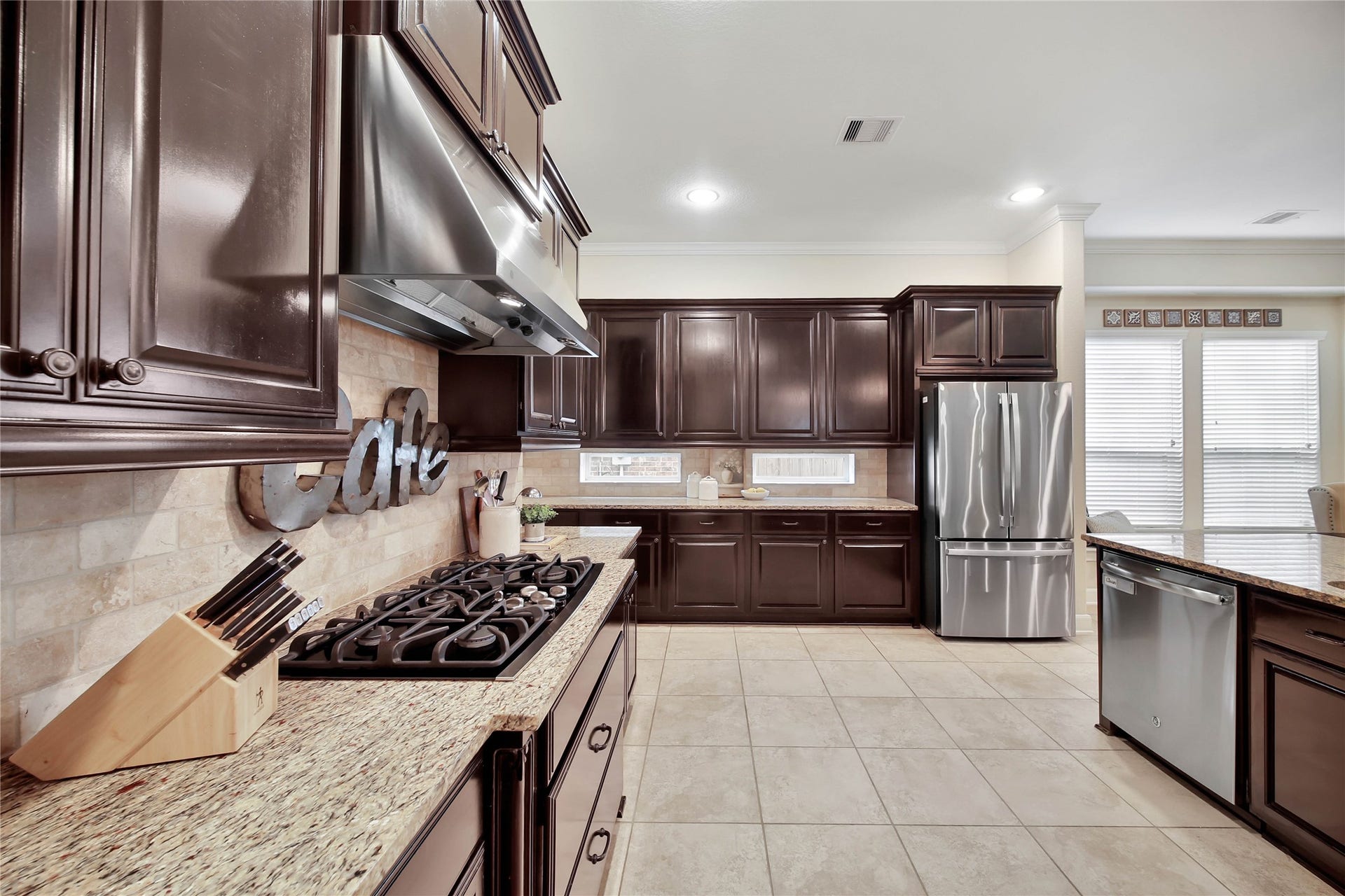 The kitchen features sleek stainless steel appliances and a gas cooktop, combining style and functionality for the perfect culinary experience.