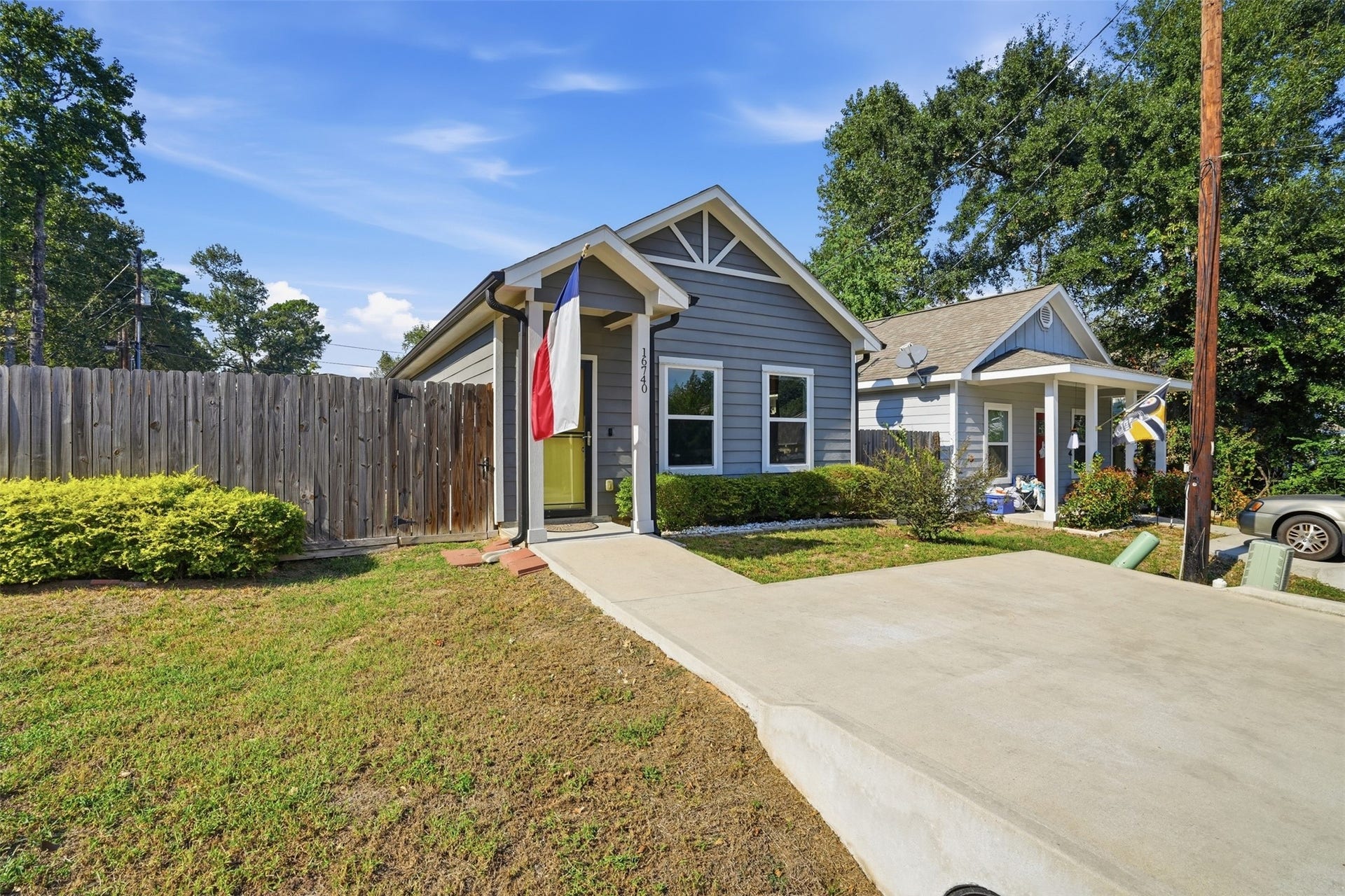 16740 Stonefield, Montgomery, TX 77316 Home with a modern gray exterior, inviting front porch, and nice landscaping, nestled in a quiet neighborhood.