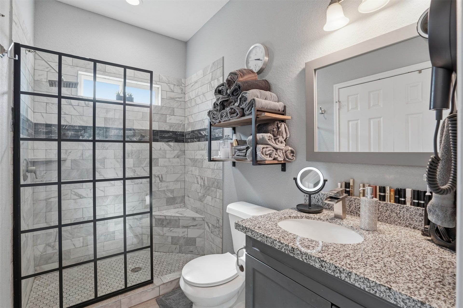 16740 Stonefield, Montgomery, TX 77316 Modern bathroom with a stylish glass-enclosed shower, marble tile backsplash, and a granite countertop.