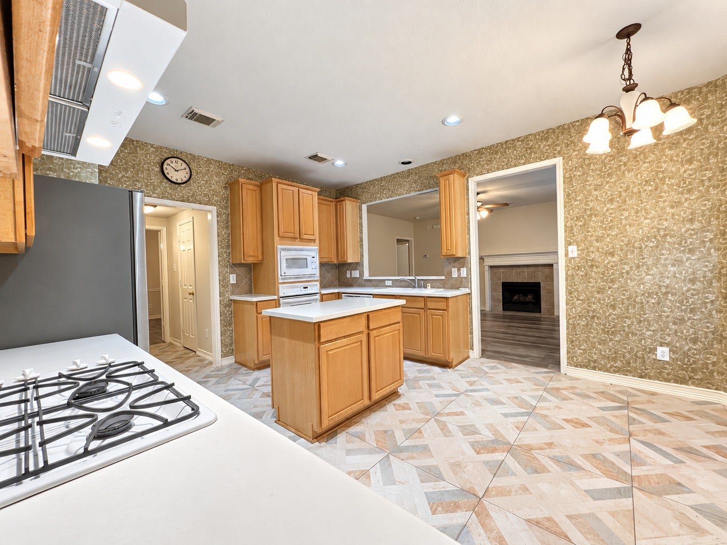 908 Azalea Pointe, League City, TX 77573 Spacious kitchen with elegant cabinetry, modern appliances, and a cozy connection to the living area, perfect for both cooking and entertaining.