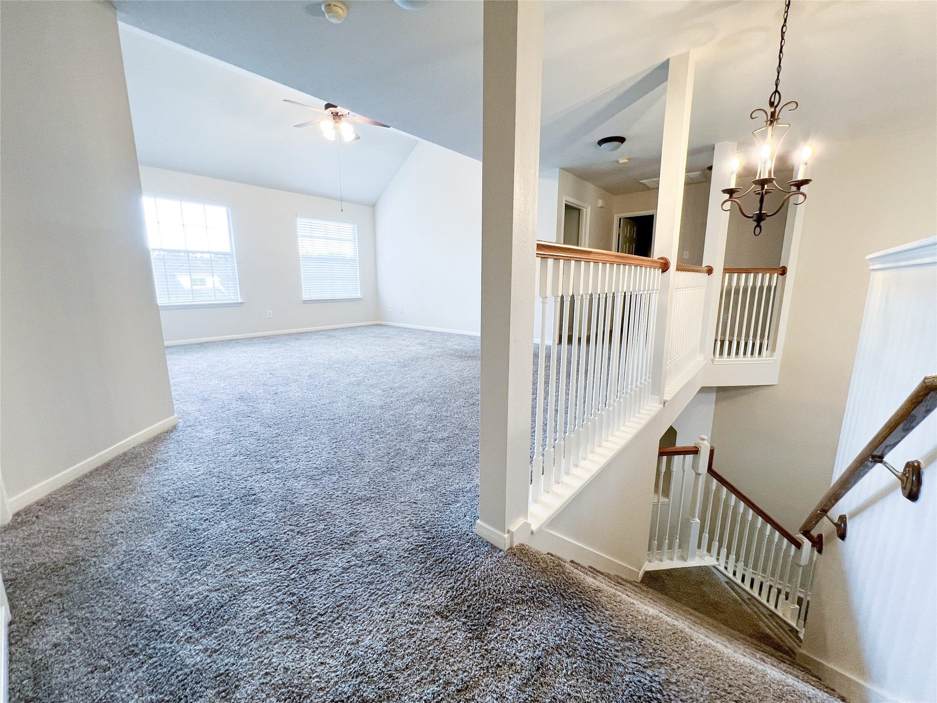 908 Azalea Pointe, League City, TX 77573 This inviting second-floor space boasts plush carpeting, elegant railing details, and abundant natural light, creating a perfect blend of comfort and style.