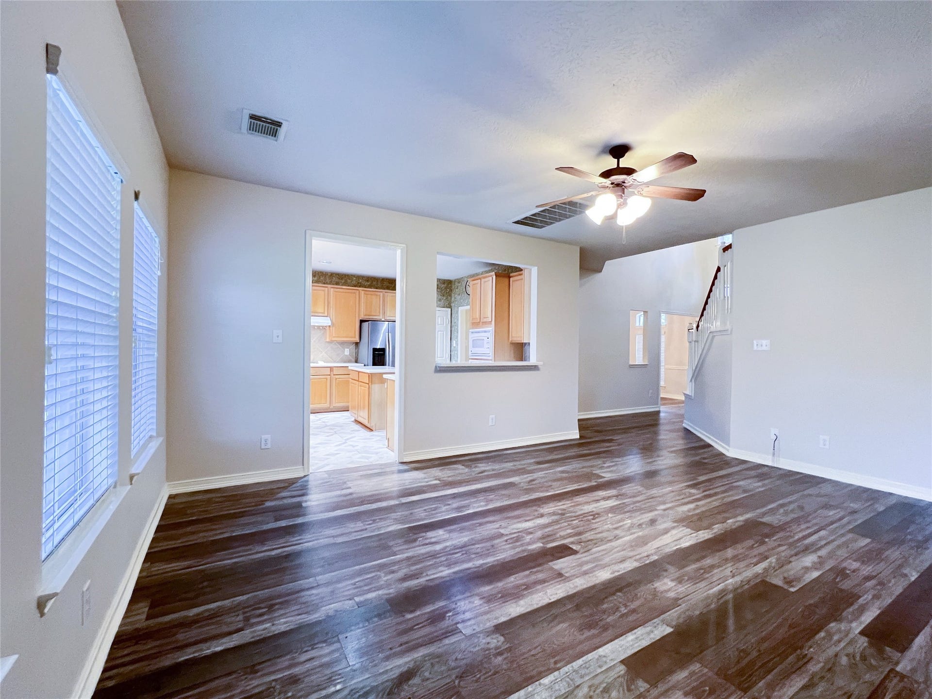 908 Azalea Pointe, League City, TX 77573 Step into this inviting living area, featuring rich floors, abundant natural light, and seamless access to the kitchen and upper level, perfect for modern living and entertaining.