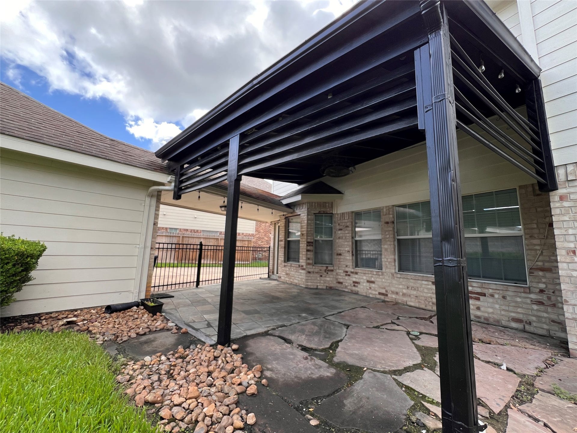 908 Azalea Pointe, League City, TX 77573 Enjoy outdoor living with this charming covered patio, perfect for relaxing or entertaining in style.