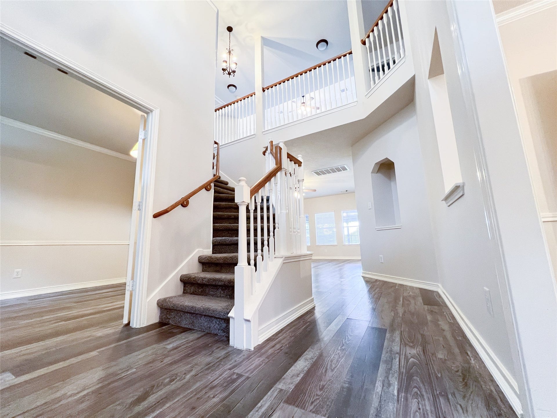 908 Azalea Pointe, League City, TX 77573 Step into elegance with this grand foyer, featuring soaring ceilings, a stylish staircase, and abundant natural light, setting a welcoming tone for the entire home.