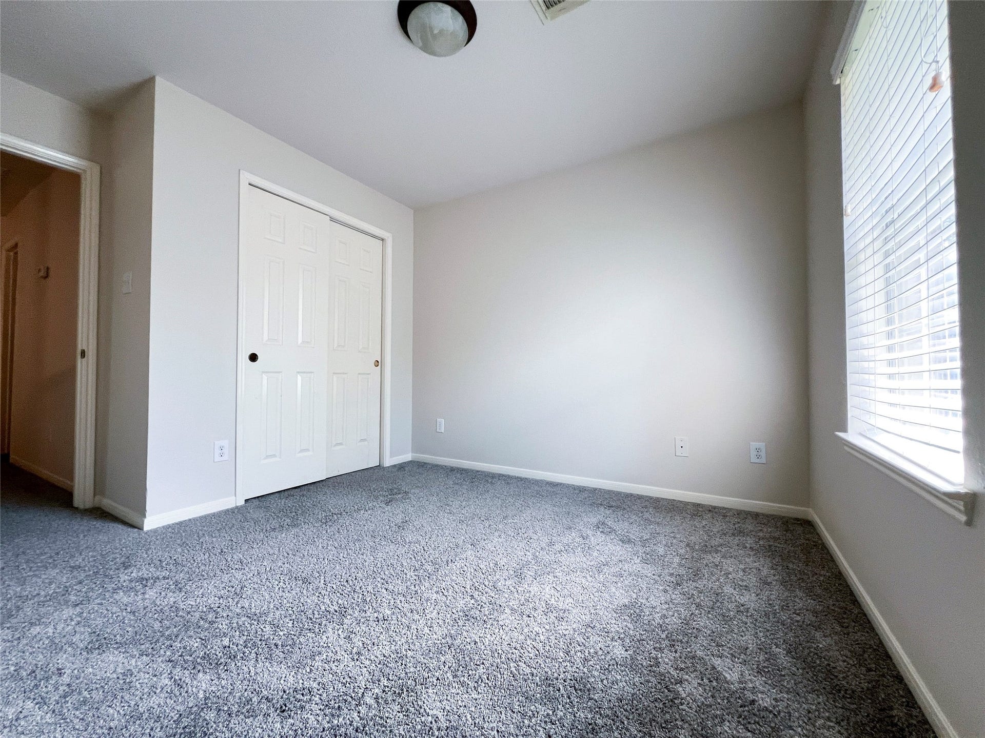 908 Azalea Pointe, League City, TX 77573 Experience comfort and tranquility in this spacious second-floor bedroom, featuring plush carpeting and abundant natural light.