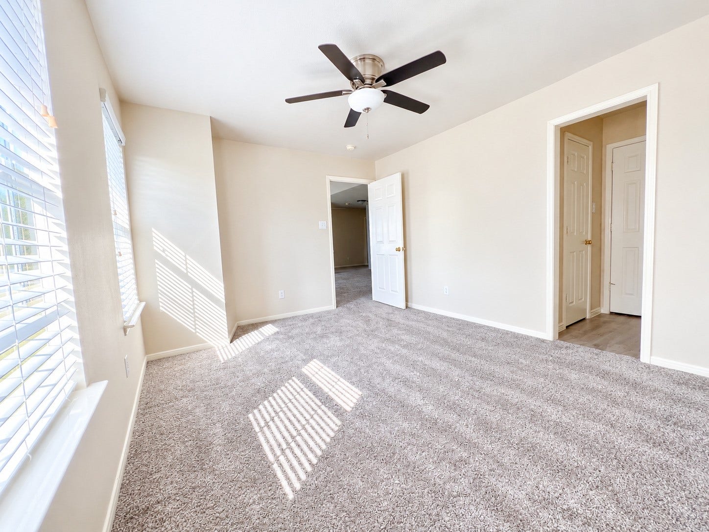908 Azalea Pointe, League City, TX 77573 Sunlit and spacious, Bedroom 3 on the second floor offers a cozy retreat with plush carpeting and a modern ceiling fan, perfect for relaxation.