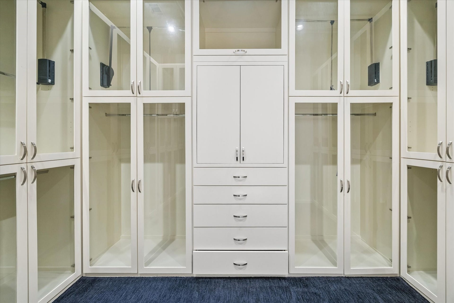 ONE OF TWO LARGE PRIMARY BEDROOM SUITE WALK-IN CLOSETS - this one fitted with glazed-insert doors to protect clothing in the hanging spaces, plus built-in storage drawers and cabinetry