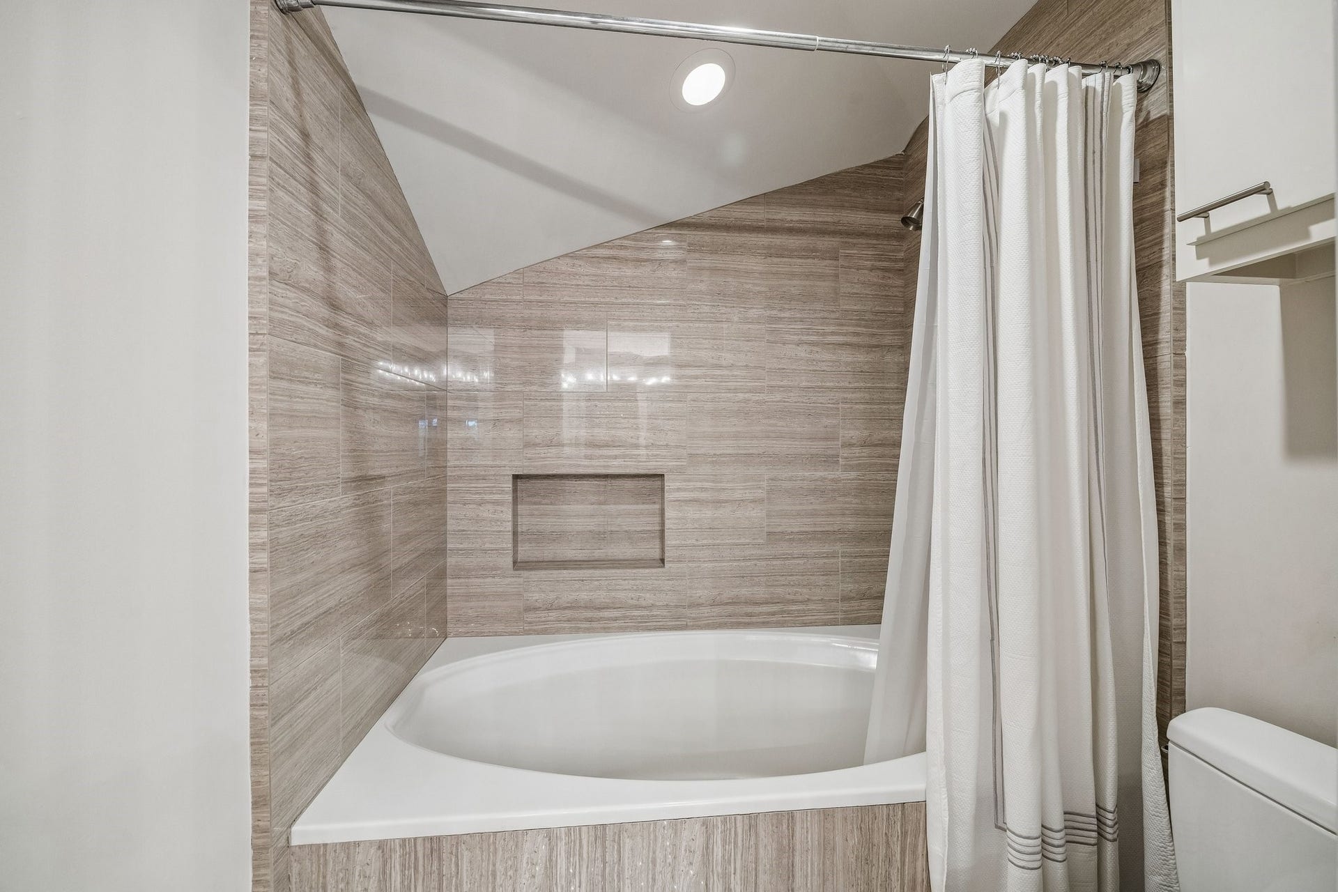 ENSUITE BATH FOR BEDROOM 2 - oversize soaking tub with shower and abundant counter space and cabinetry for towels and toiletries, large walk-in closet with built-ins (not shown)