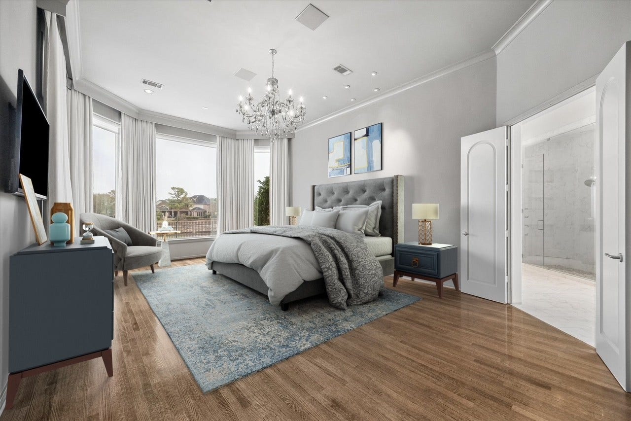 VIRTUALLY STAGED - elegant primary bedroom in a serene color palette - beautiful chandelier and recessed lighting, hardwood flooring