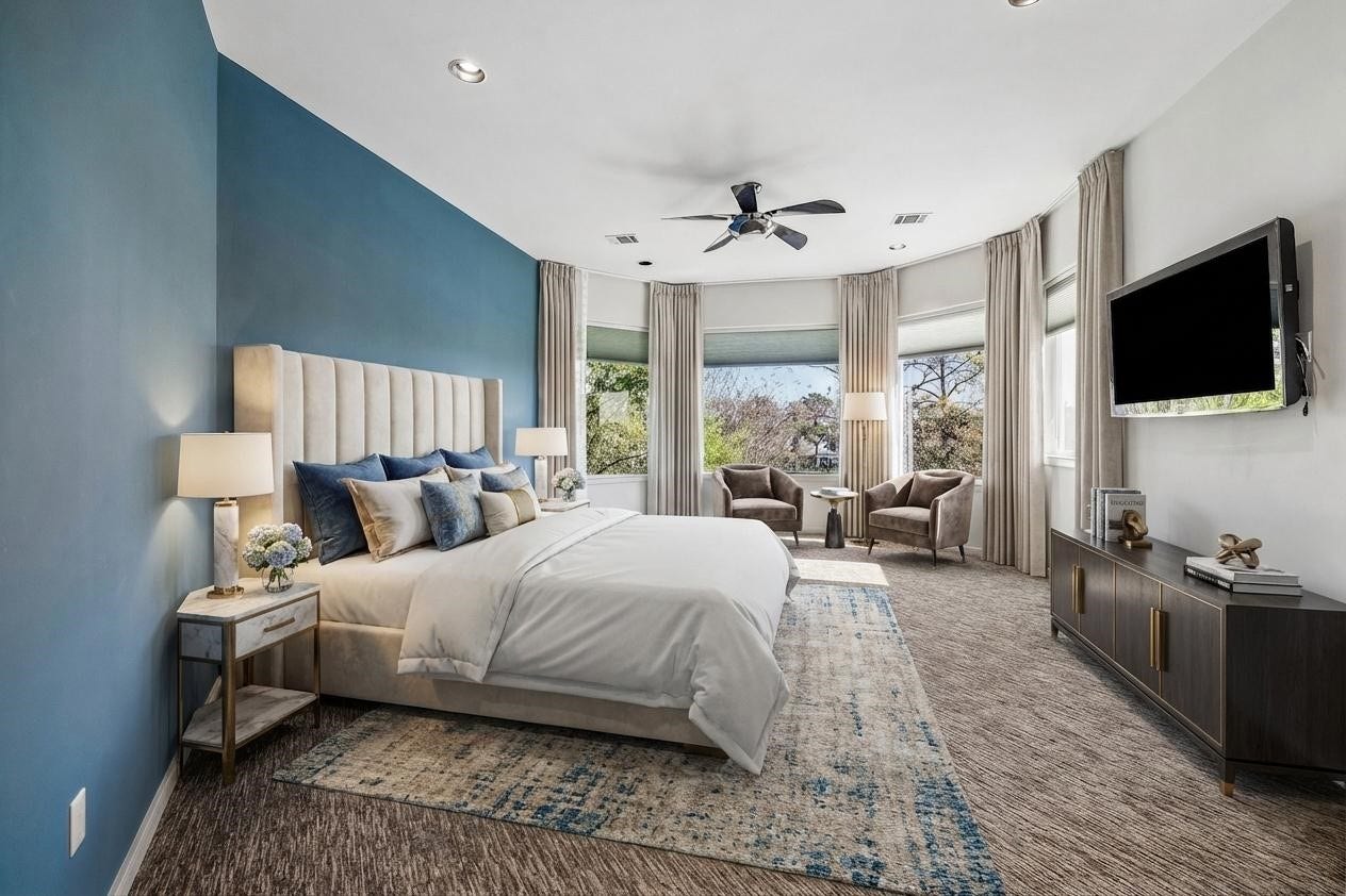 VIRTUALLY STAGED - spacious ensuite bedroom 4 upstairs - dramatic blue accent wall, wall of windows providing beautiful views over the lake and golf course, wall-mounted TV is included