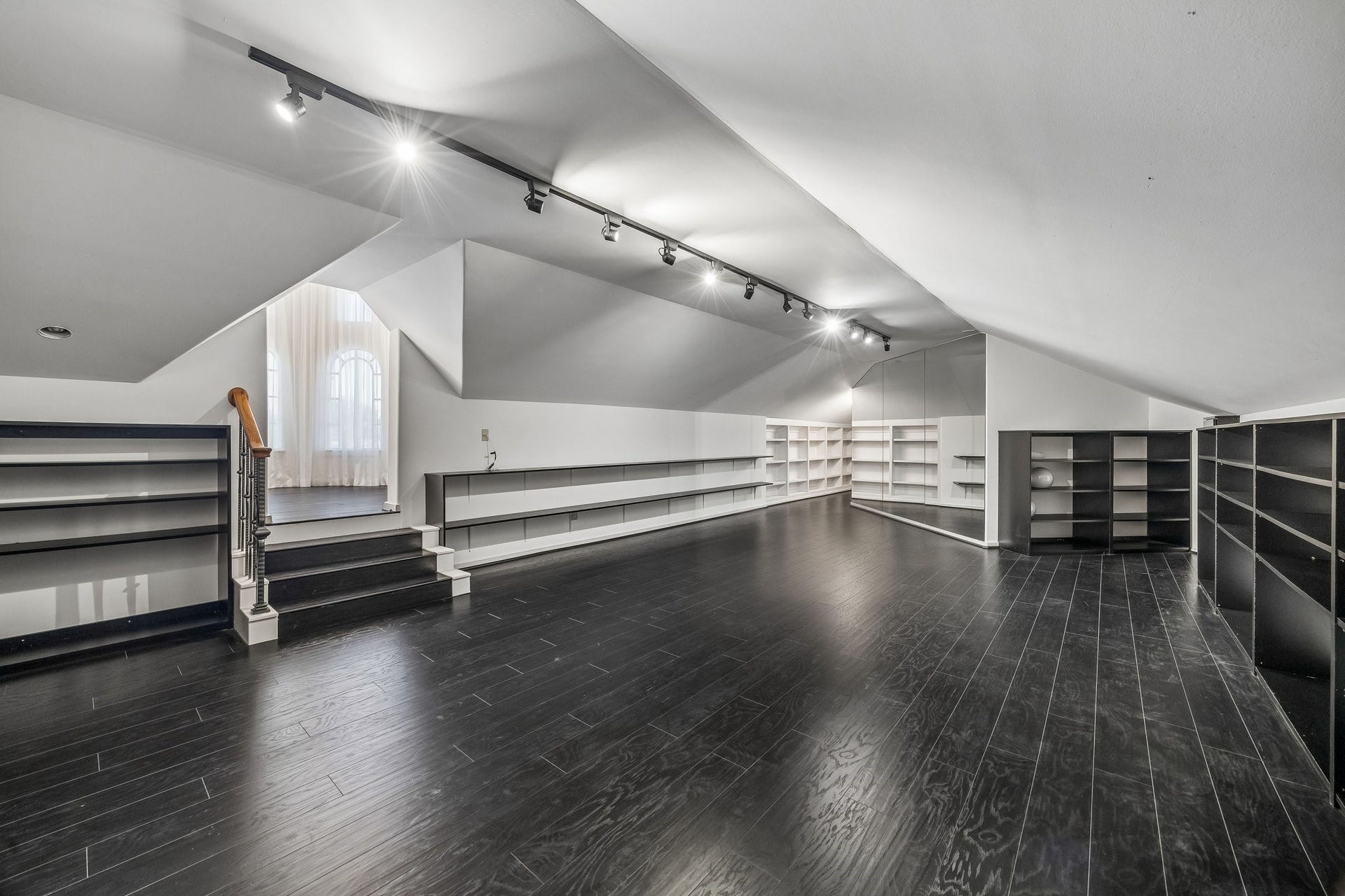 WOW!  SPACIOUS MULTI-PURPOSE ROOM IDEAL FOR EXERCISE, DANCE, CRAFTS, LIBRARY, ARTIST STUDIO AND MORE - abundant built-in shelving throughout, steps lead to a wonderful 'cupola' room with TV