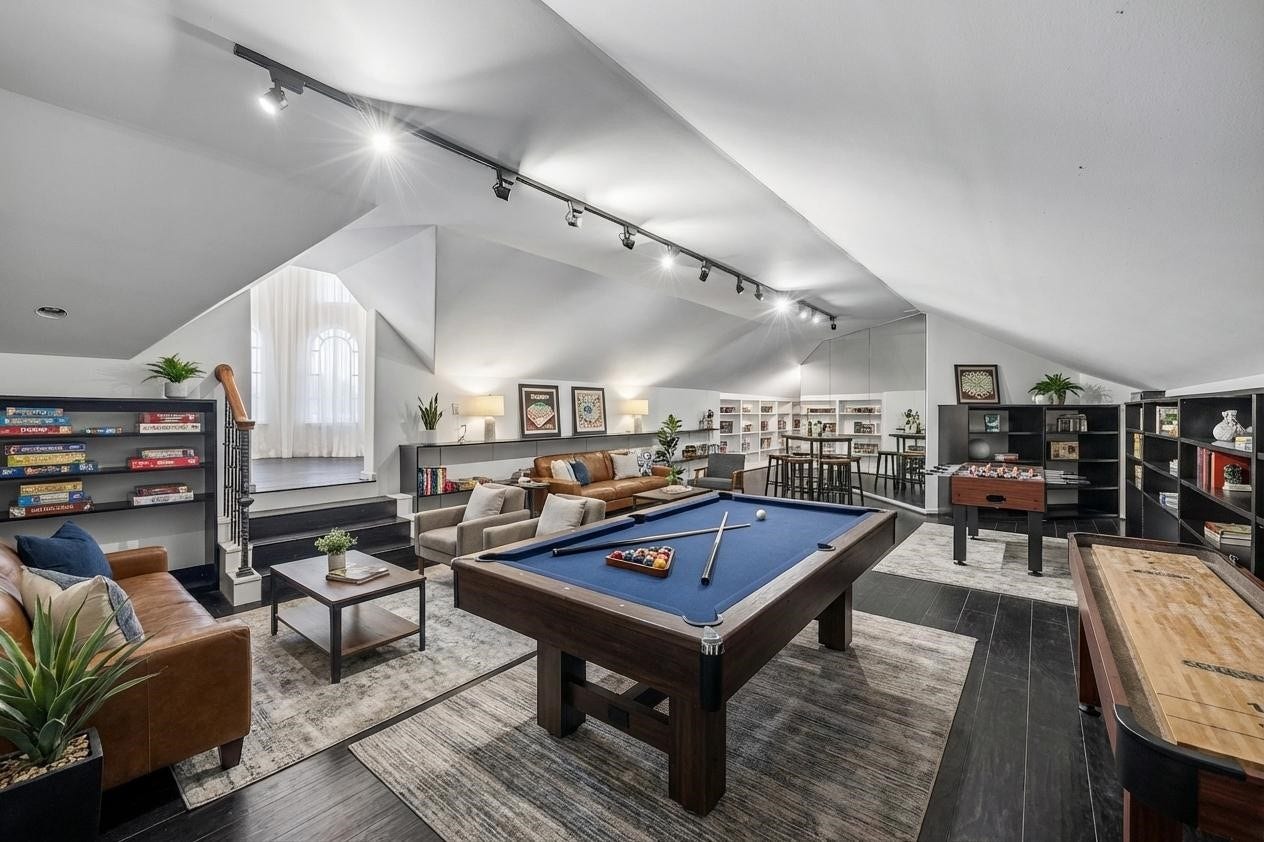 VIRTUALLY STAGED - an ideal place for the whole family to hang out, with comfortable seating for a crowd - plus a pool table + foosball, puzzles and games - even a high-top table with stools