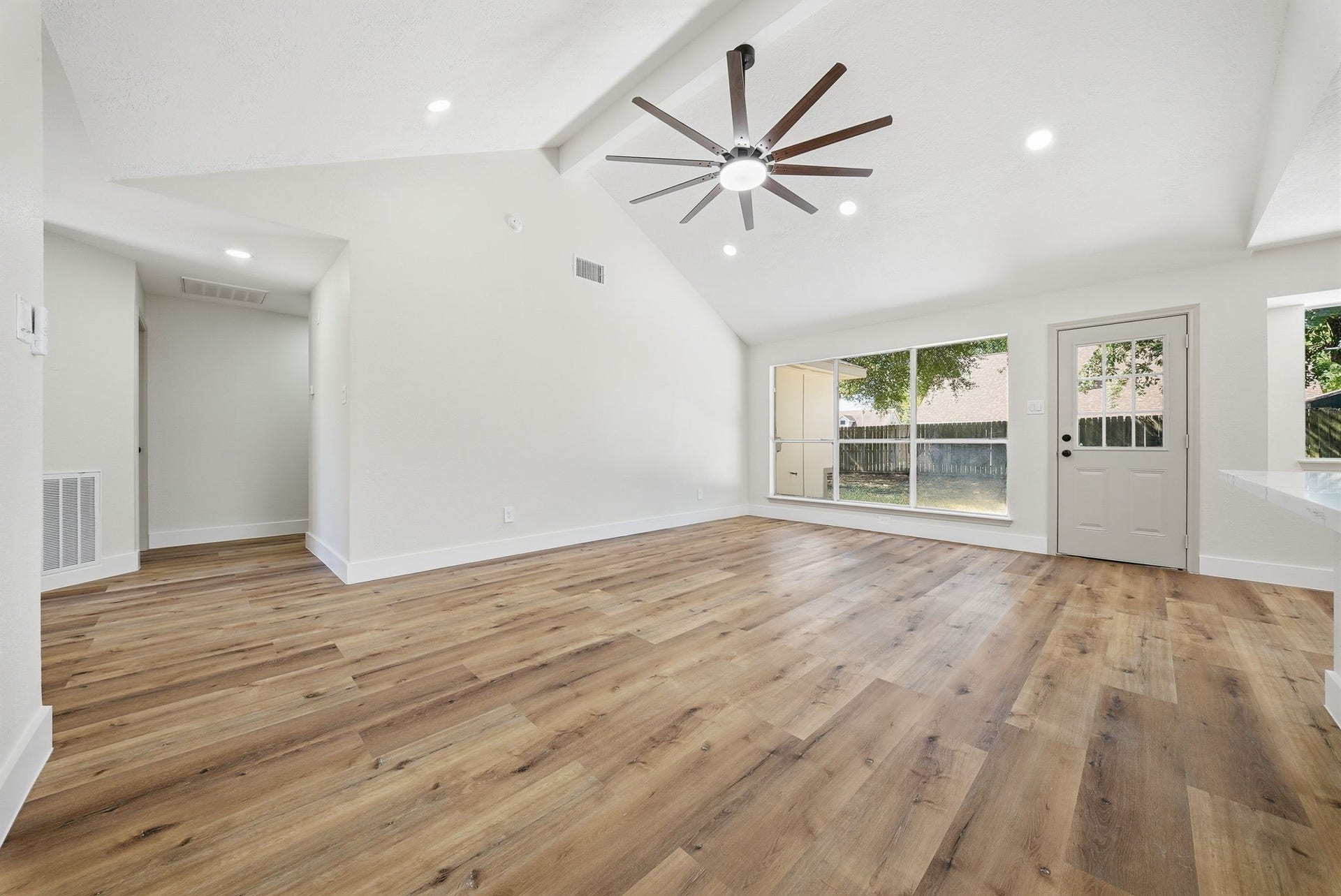 3816 Youpon Drive, La Porte, TX 77571 Spacious living area with abundant natural light from large windows with view of and door with access to yard, creating a bright and inviting atmosphere.