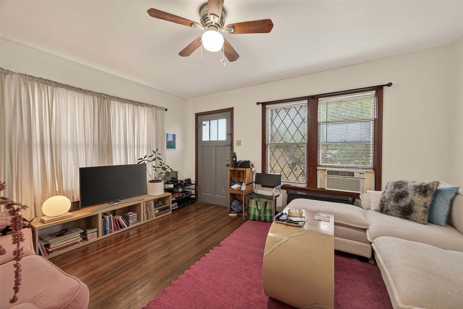516 N Eastwood Street, Houston, TX 77011 The living area with beautiful hardwood floors and wood-framed windows that add warmth and timeless appeal.