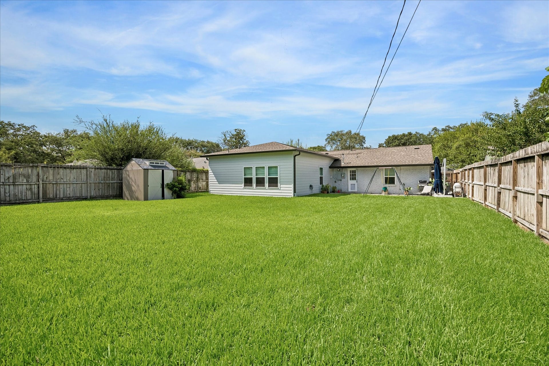 Big fenced back yard w/ drainage system & shed