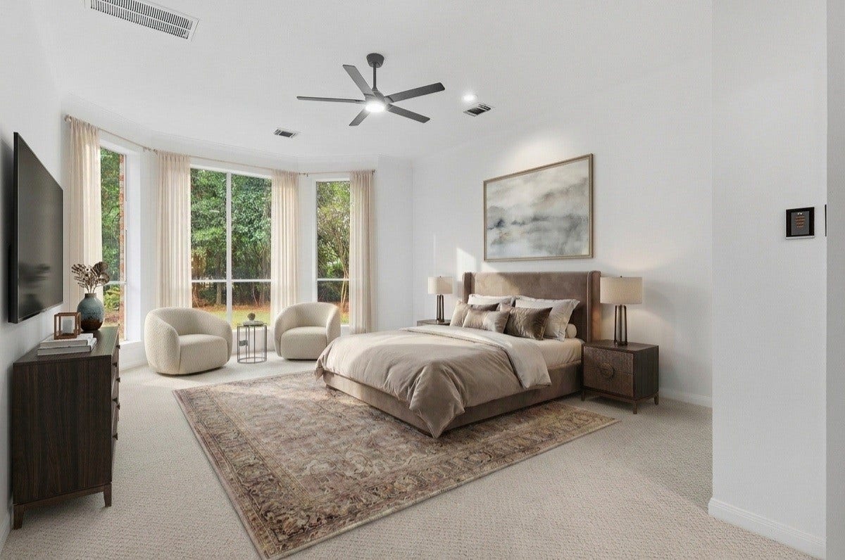 Primary Bedroom on 1st Floor. Has a view of the tree lined backyard and pool. -VIRTUALLY STAGED-