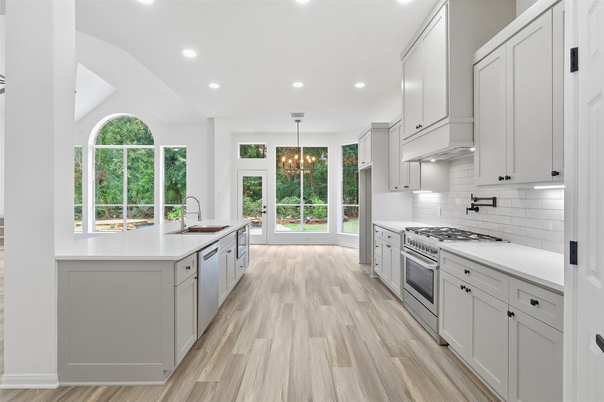 New custom cabinetry, quartz counters, white subway tile, microwave drawer, gas range with pot filler, under-cabinet lighting, soft-close drawers and cabinets. High-end kitchen designed for elevated everyday living.