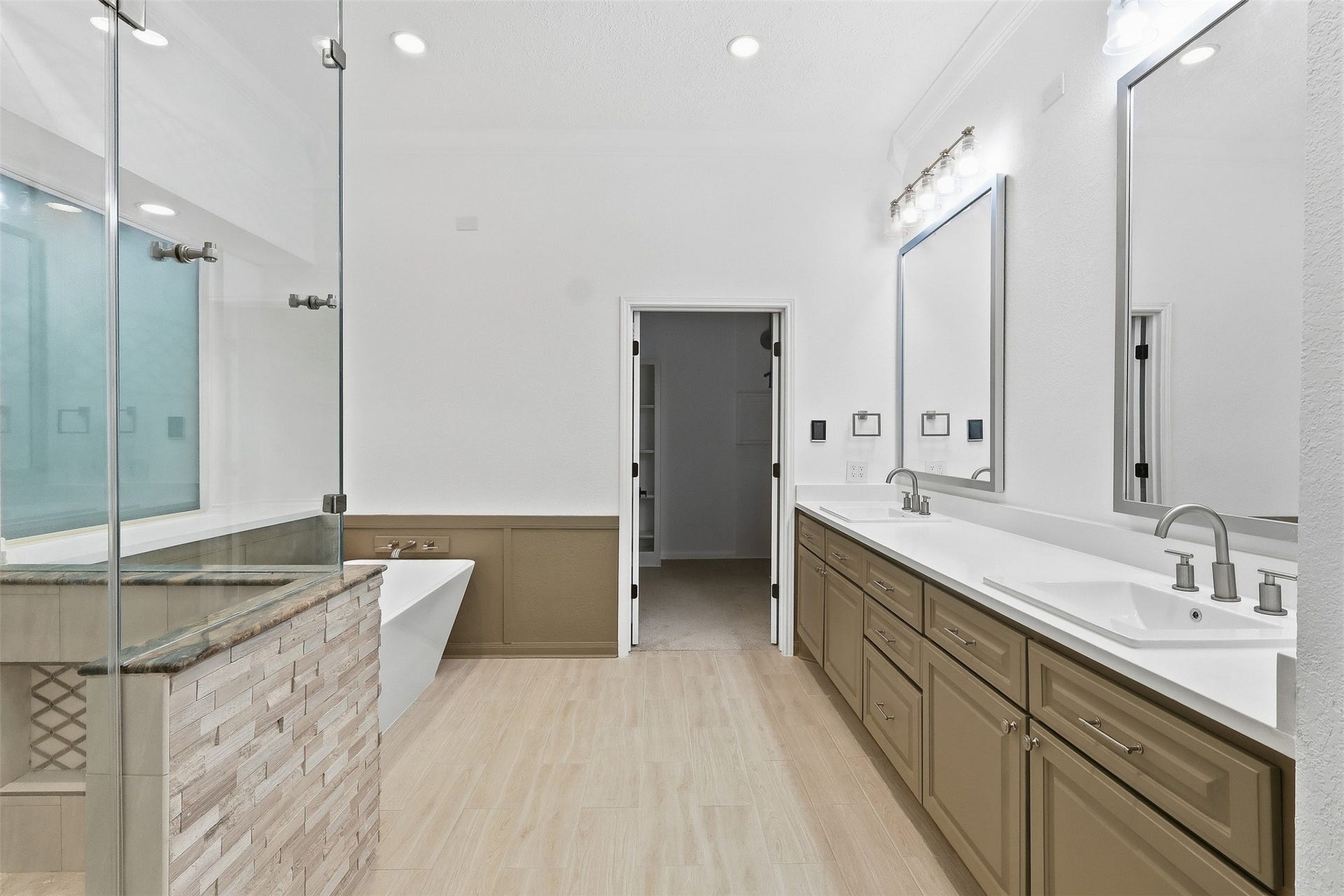 Primary bath with double-sink vanity with soft closing cabinets.