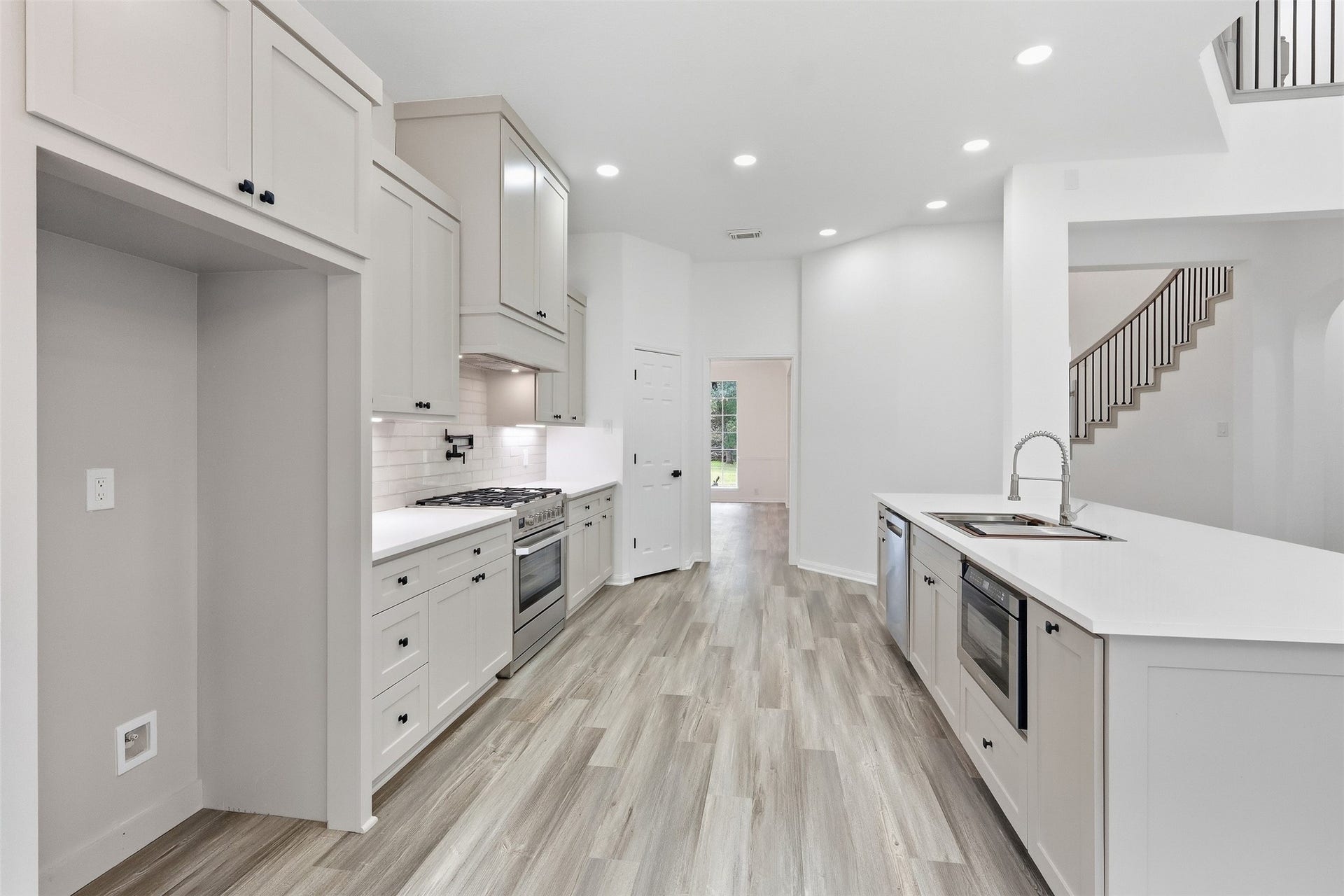 Recessed lighting brightens the entire kitchen space.