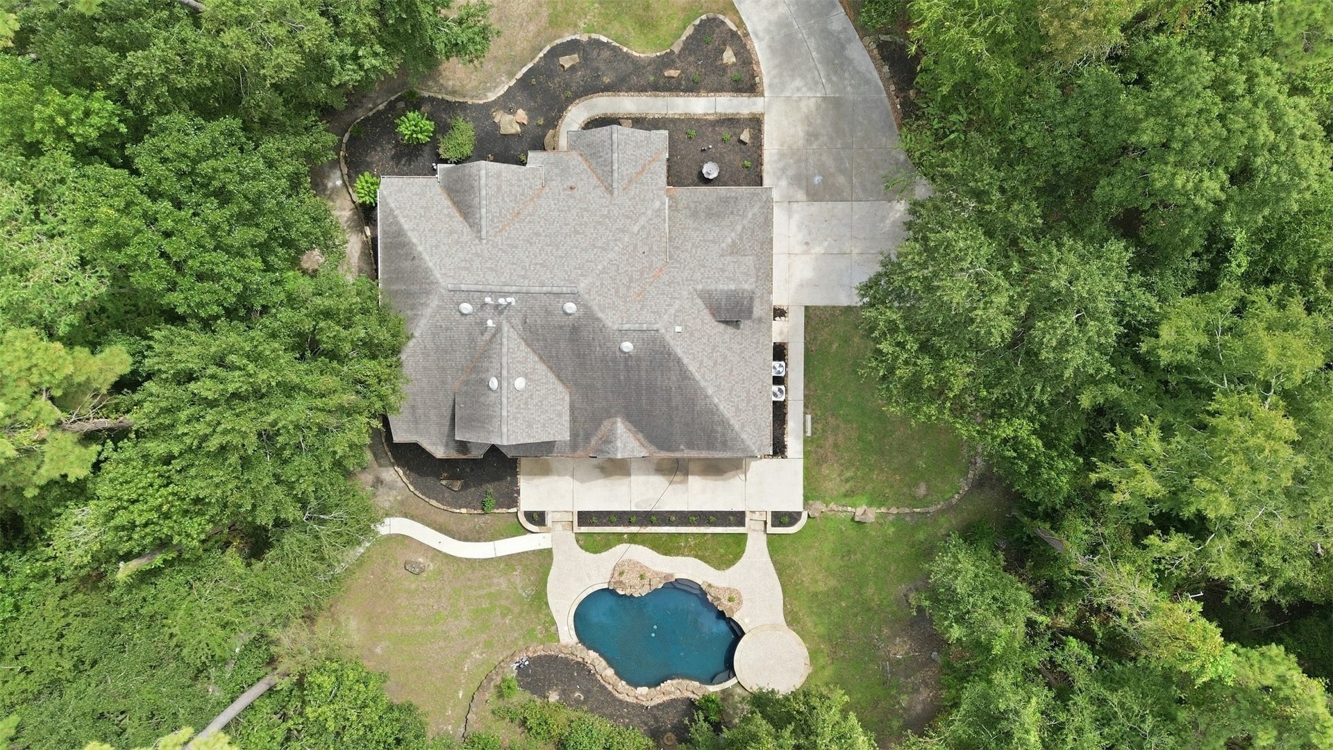 Beautiful mature trees surround the home, offering natural privacy and a peaceful, secluded feel.
