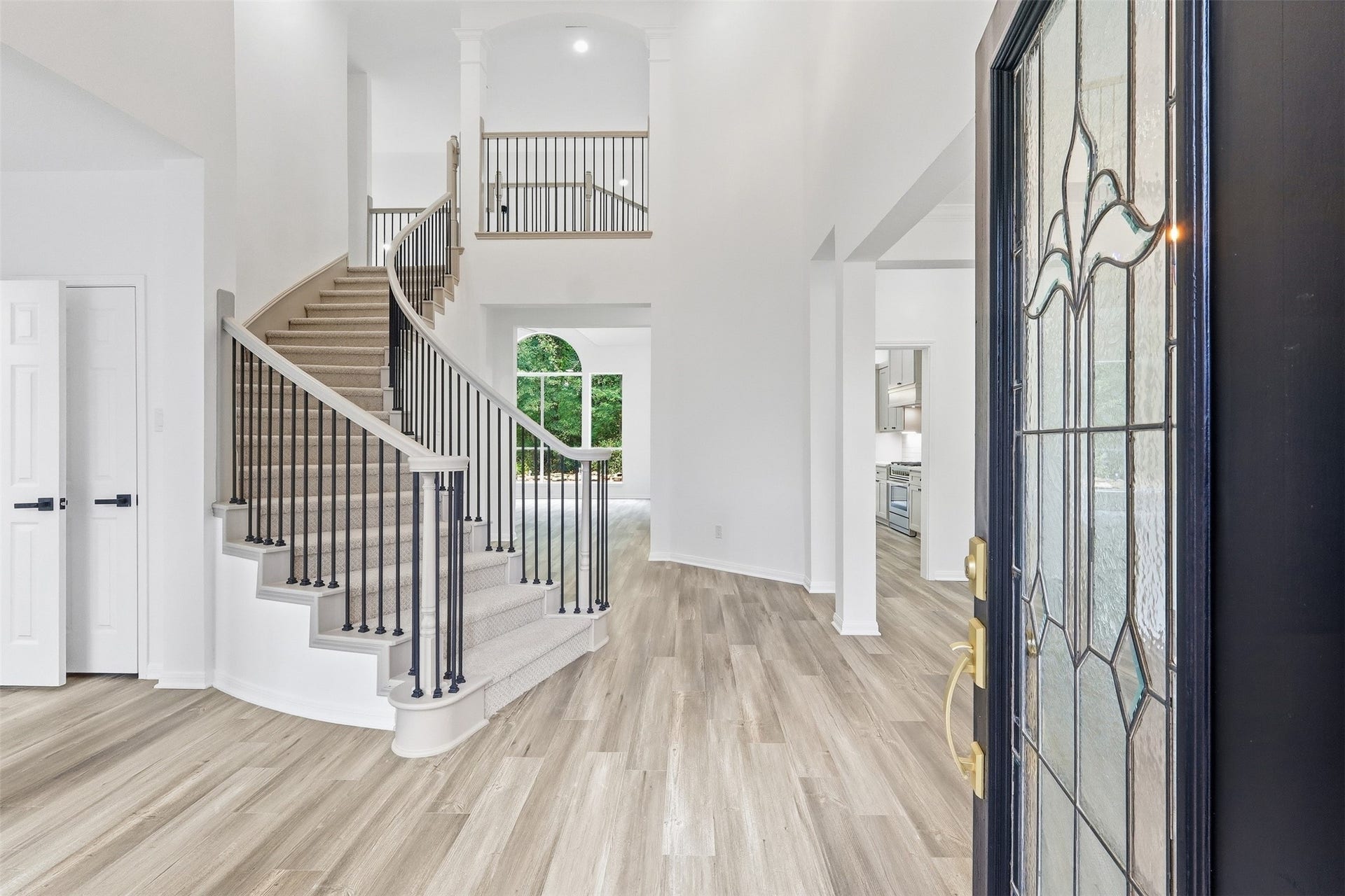 Stunning entry with a dramatic ceiling, sweeping staircase with iron spindles. You have a formal living to the left and formal dining to the right of entry.