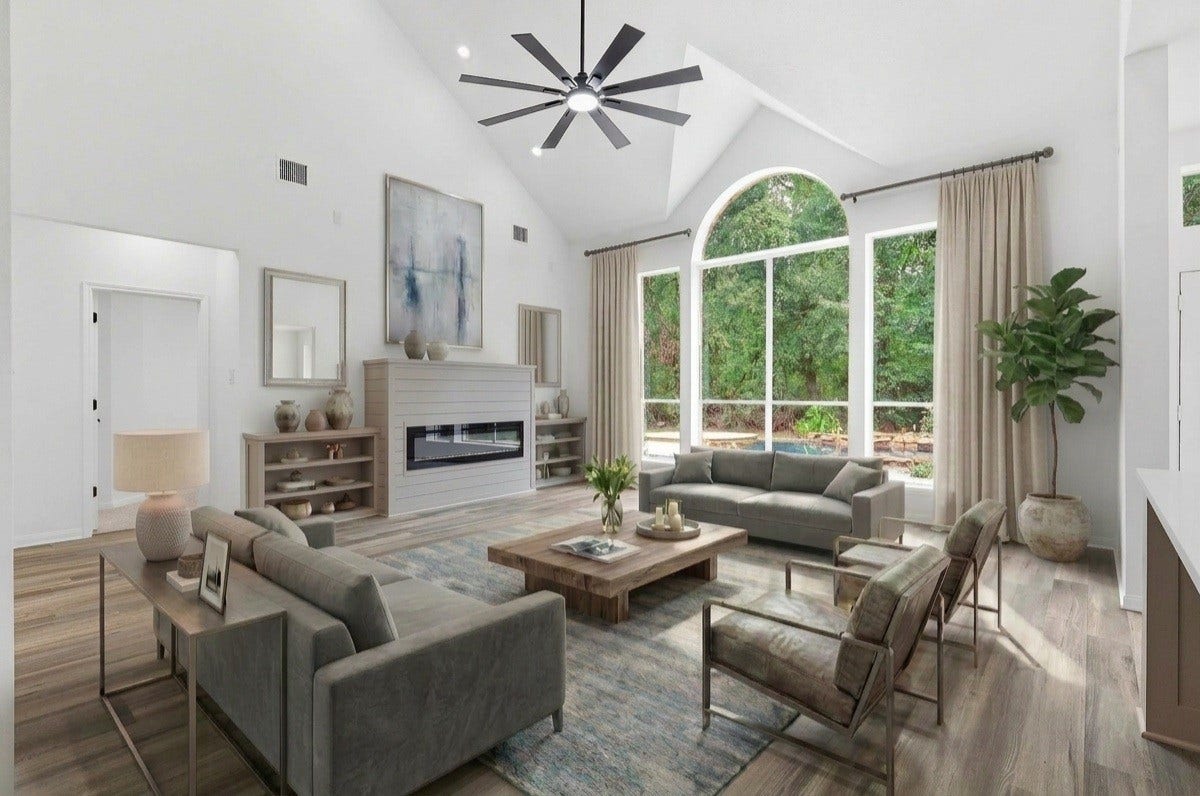 Living room with soaring vaulted ceilings, an electric fireplace framed by built-ins, and a large arched window that fills the space with natural light and offers a clear view of the pool. -VIRTUALLY STAGED-