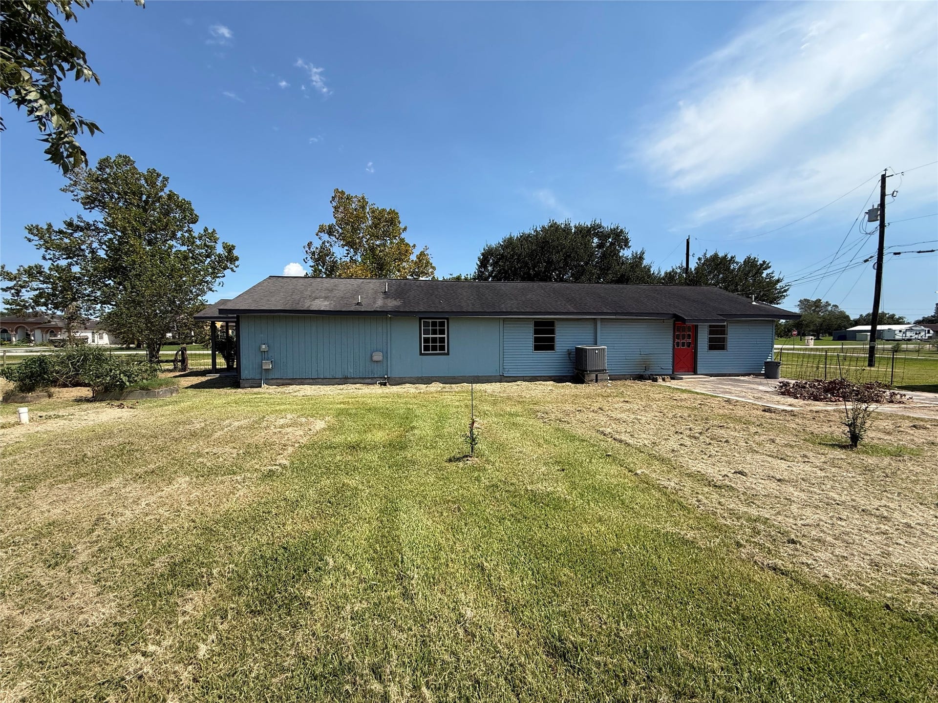 2524 Shouse Road, Santa Fe, TX 77510 Rear exterior overlooking the open backyard and concrete patio.